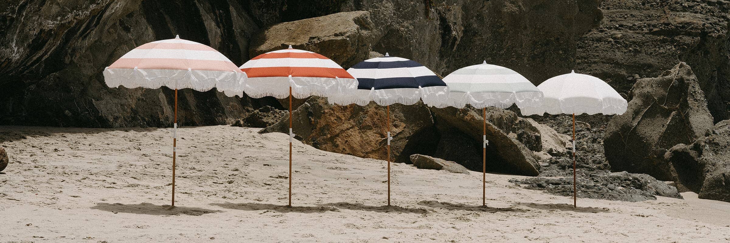 Holiday Beach Umbrellas in five colors in the sand
