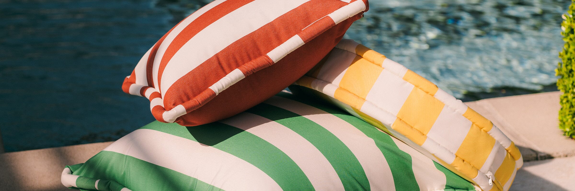 Brightly colored outdoor pillows on a lawn