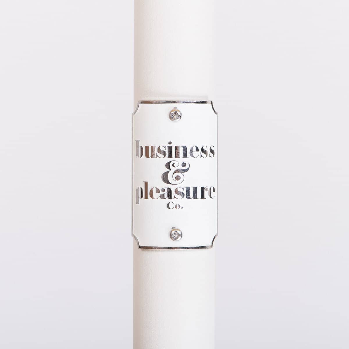 white umbrella pole with badge and logo