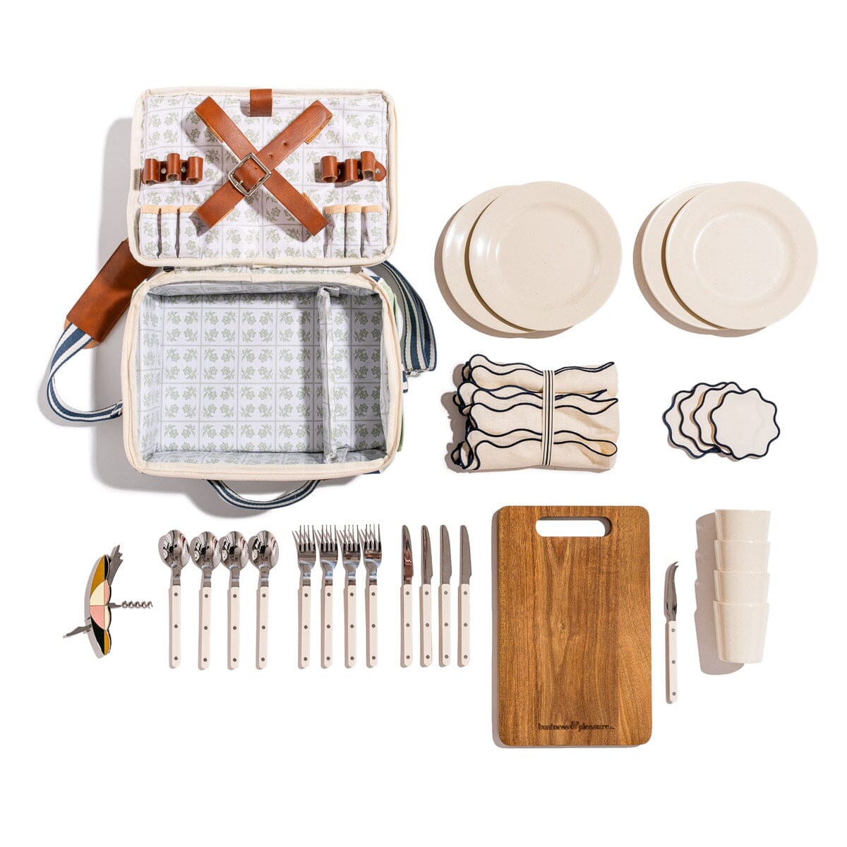 Picnic set with cooler bag, plates, cutlery, and cutting board on a white background