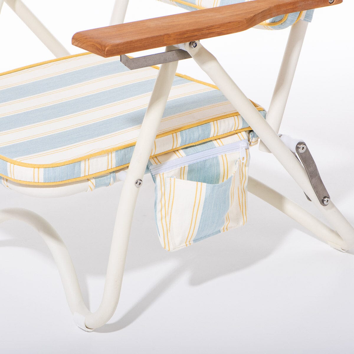 Close-up of a folding chair with striped cushion and wooden armrest on a white background