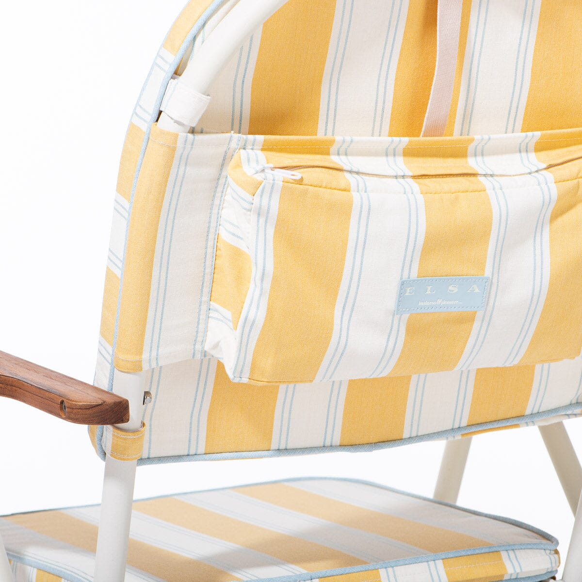 Close-up of a yellow and white striped chair with a visible brand label.