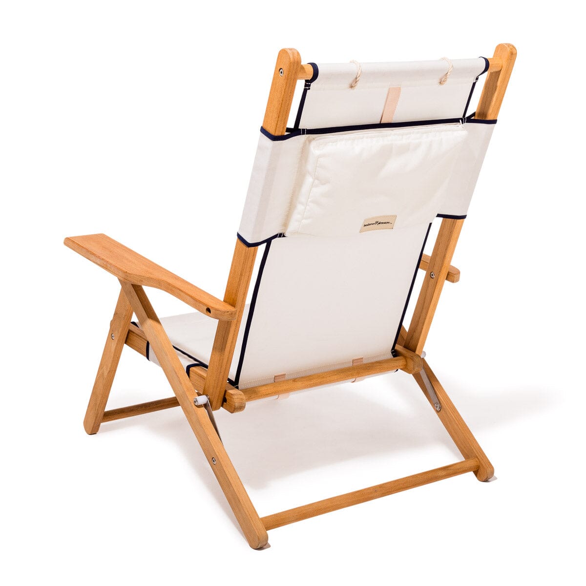 Wooden deck chair with white canvas seat and backrest with navy blue piping