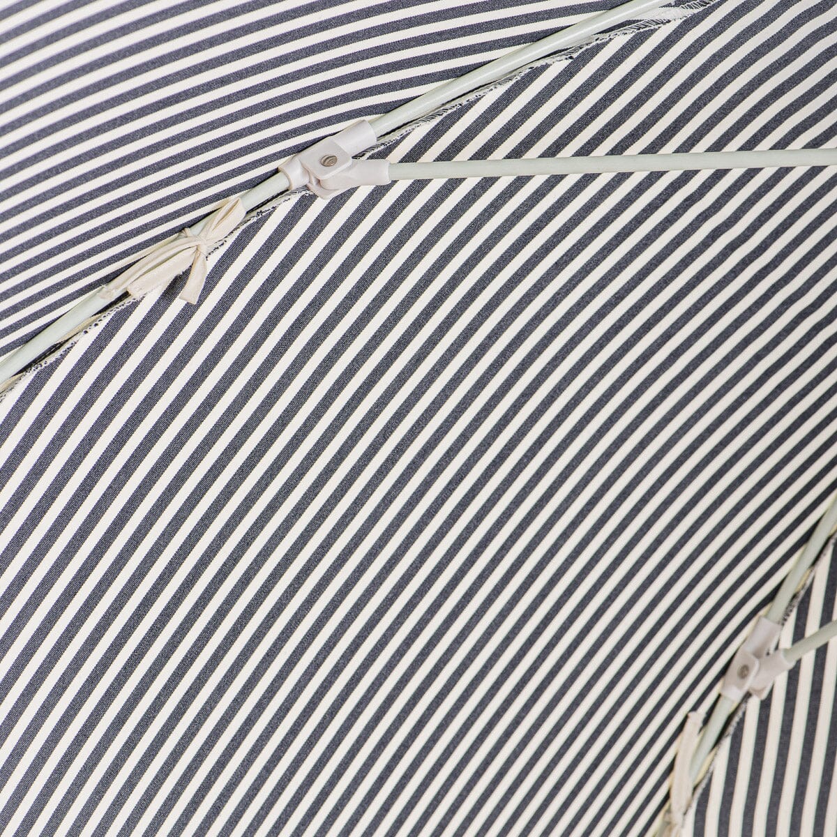 close up of canopy ties on navy stripe patio umbrella