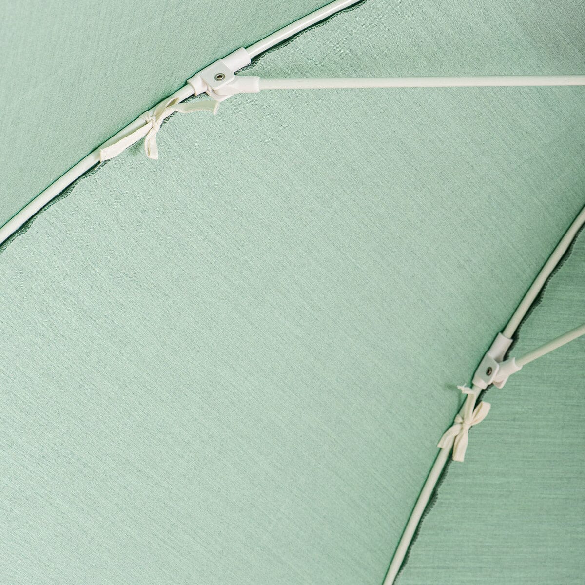 canopy ties close up detail on green patio umbrella