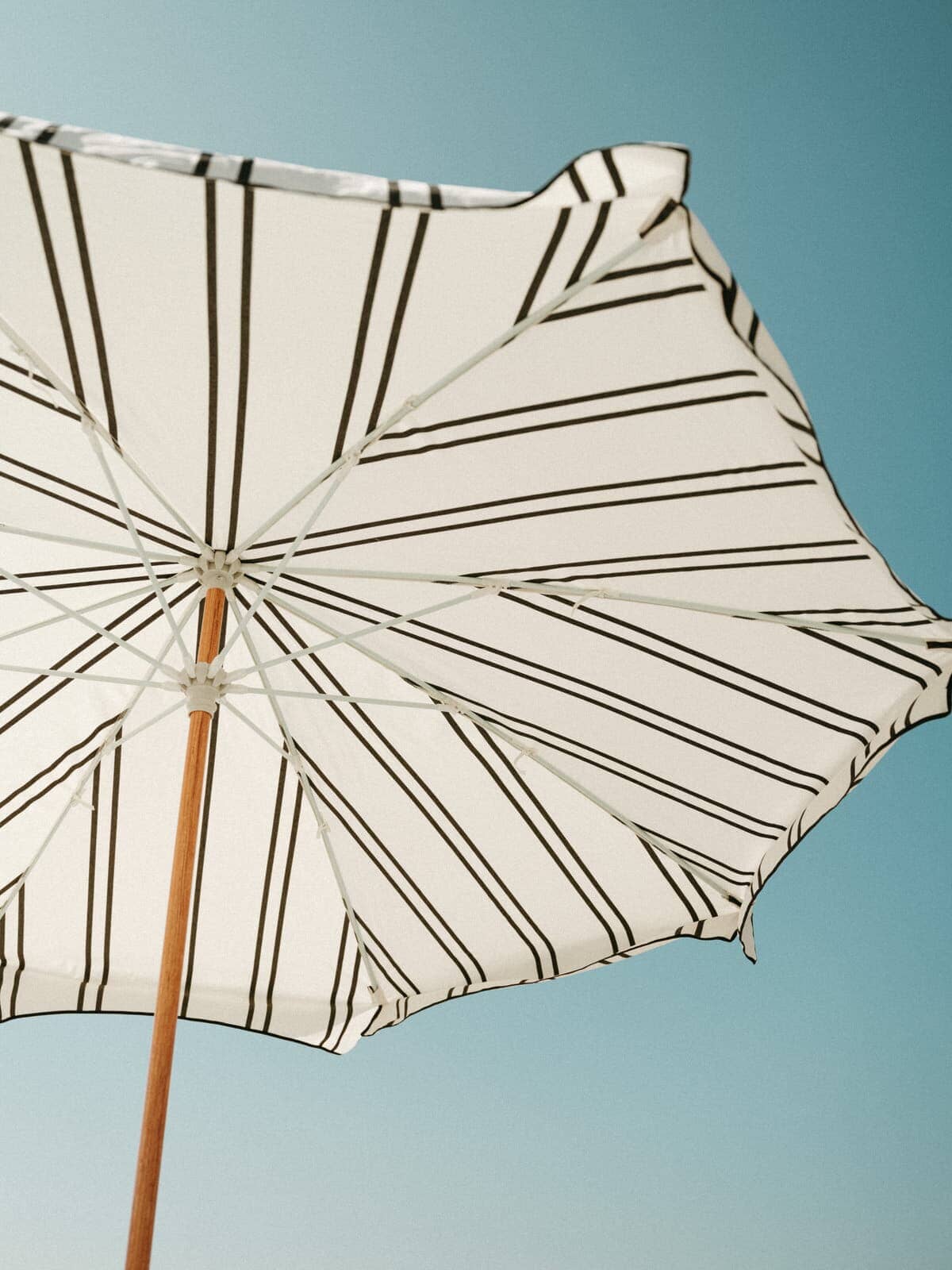 black two stripe amalfi umbrella on the beach