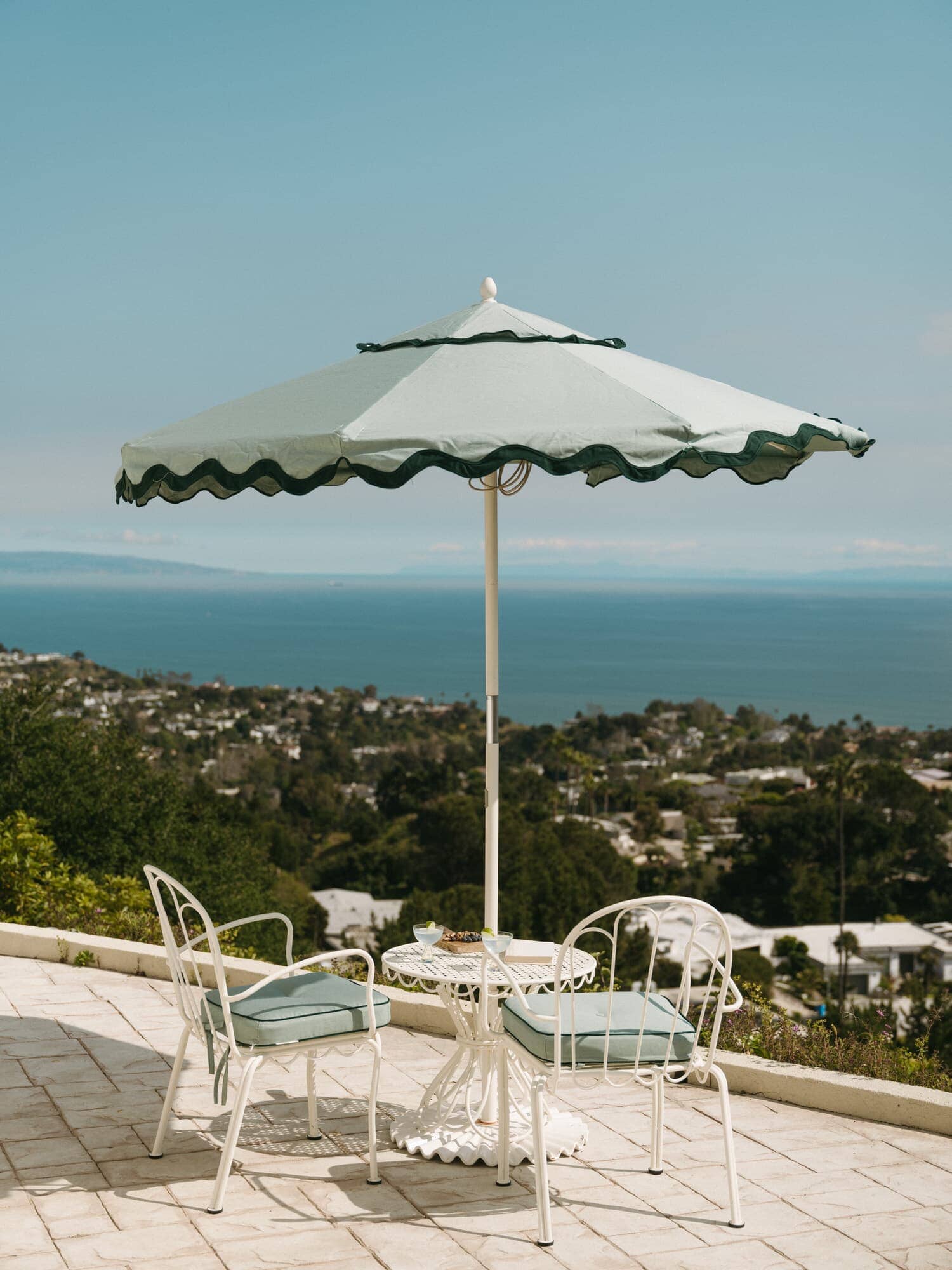 Riviera green umbrella and chairs on a patio