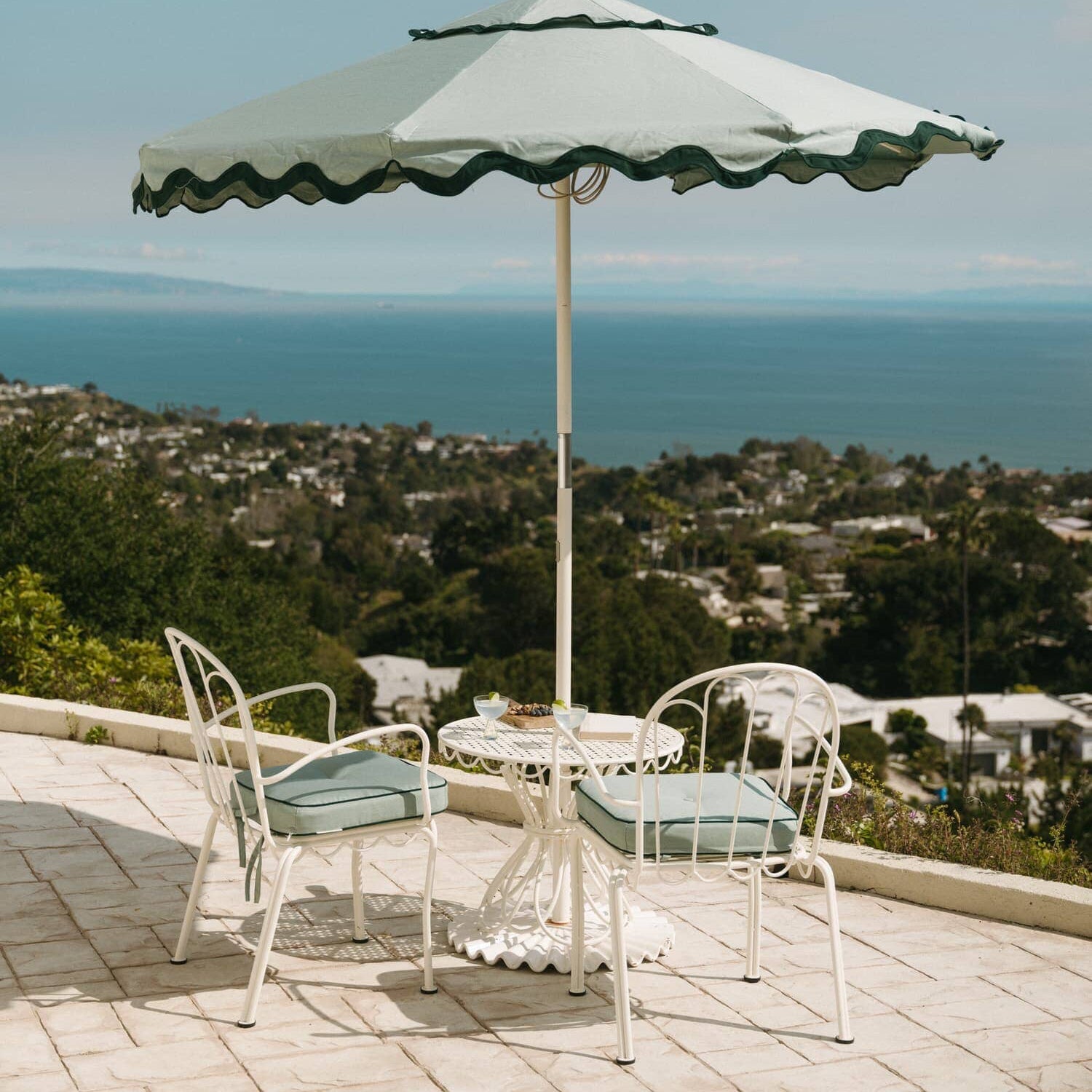 Riviera green umbrella and chairs on a patio