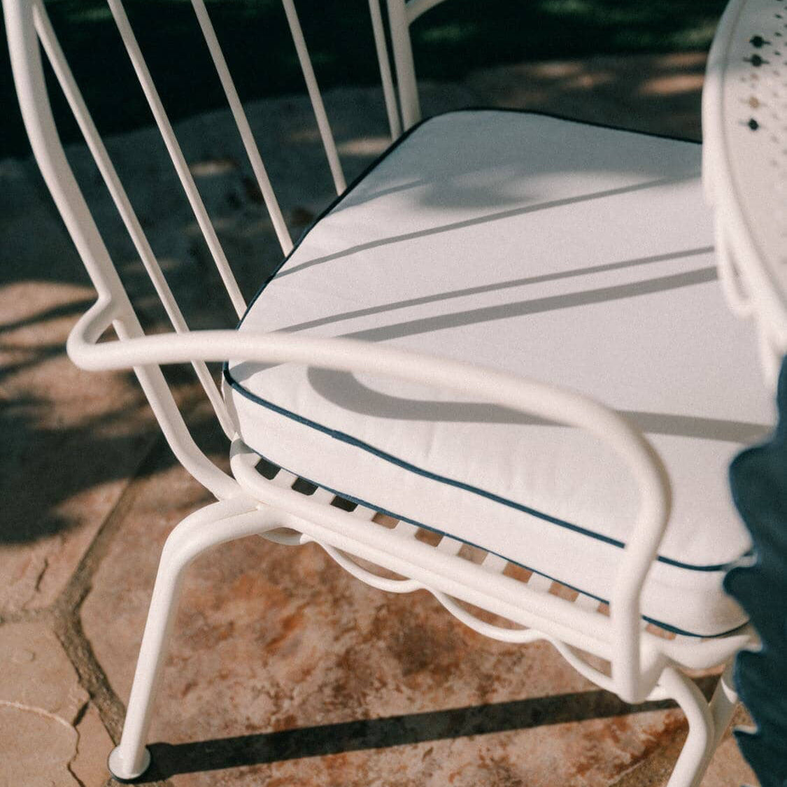 White seat cushion on a seat in the garden