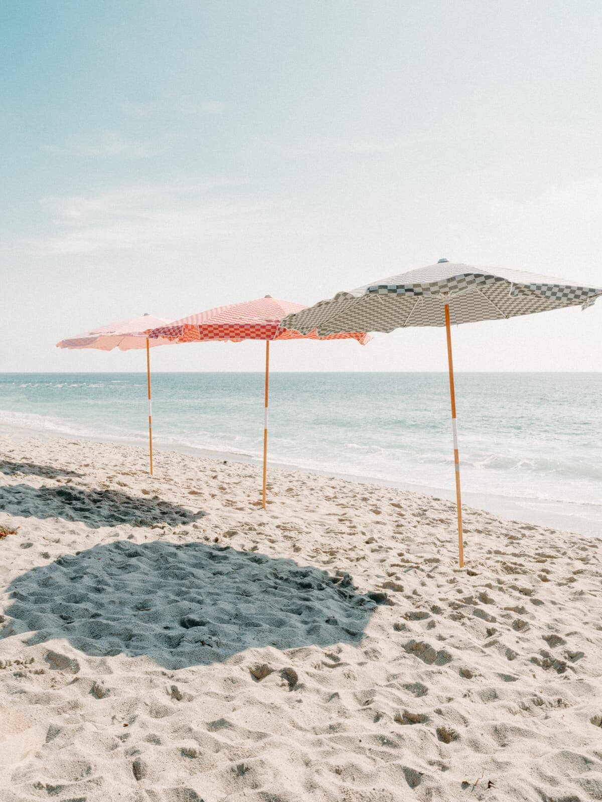 three check amalfi umbrellas on the beach