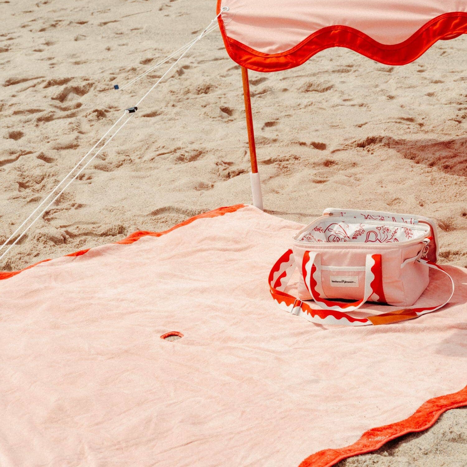 riviera pink tent, blanket and cooler on the beach