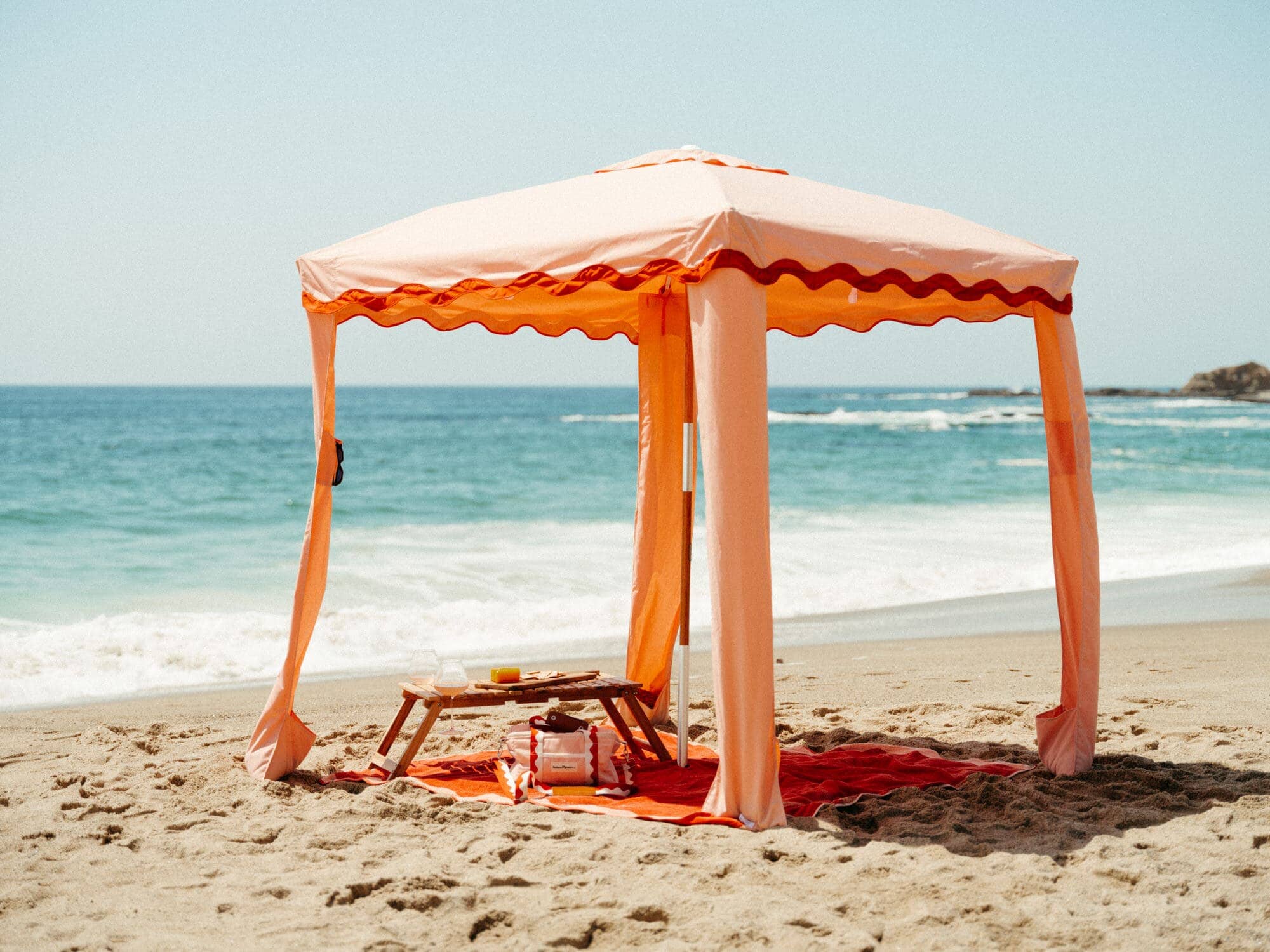 Riviera pink cabana with matching accessories on the beach