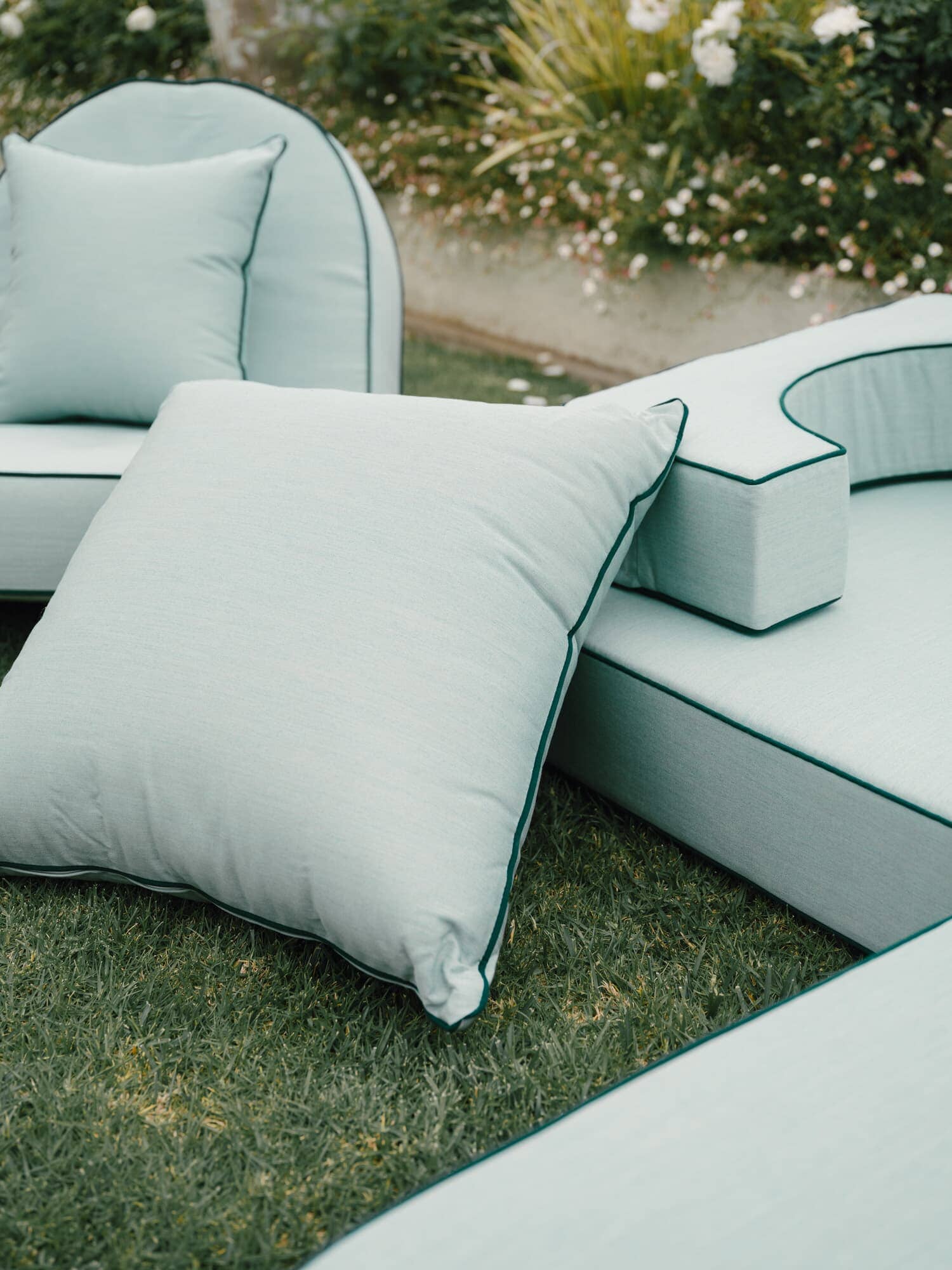 Riviera Green outdoor pillows on grass