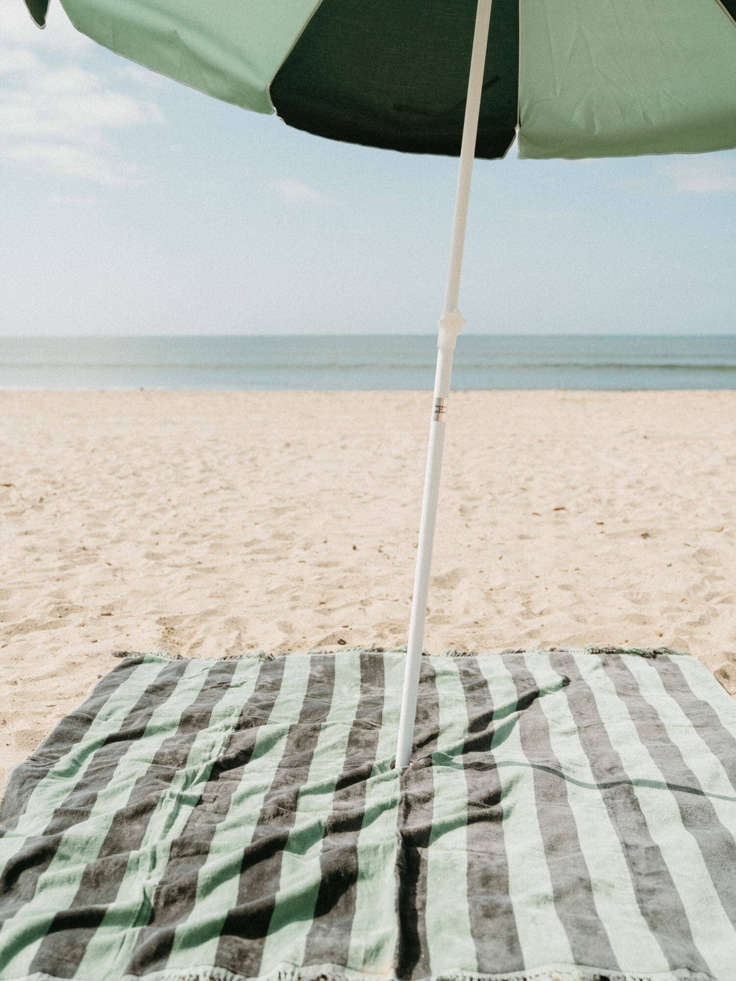&0s panel green blanket with umbrella on the beach