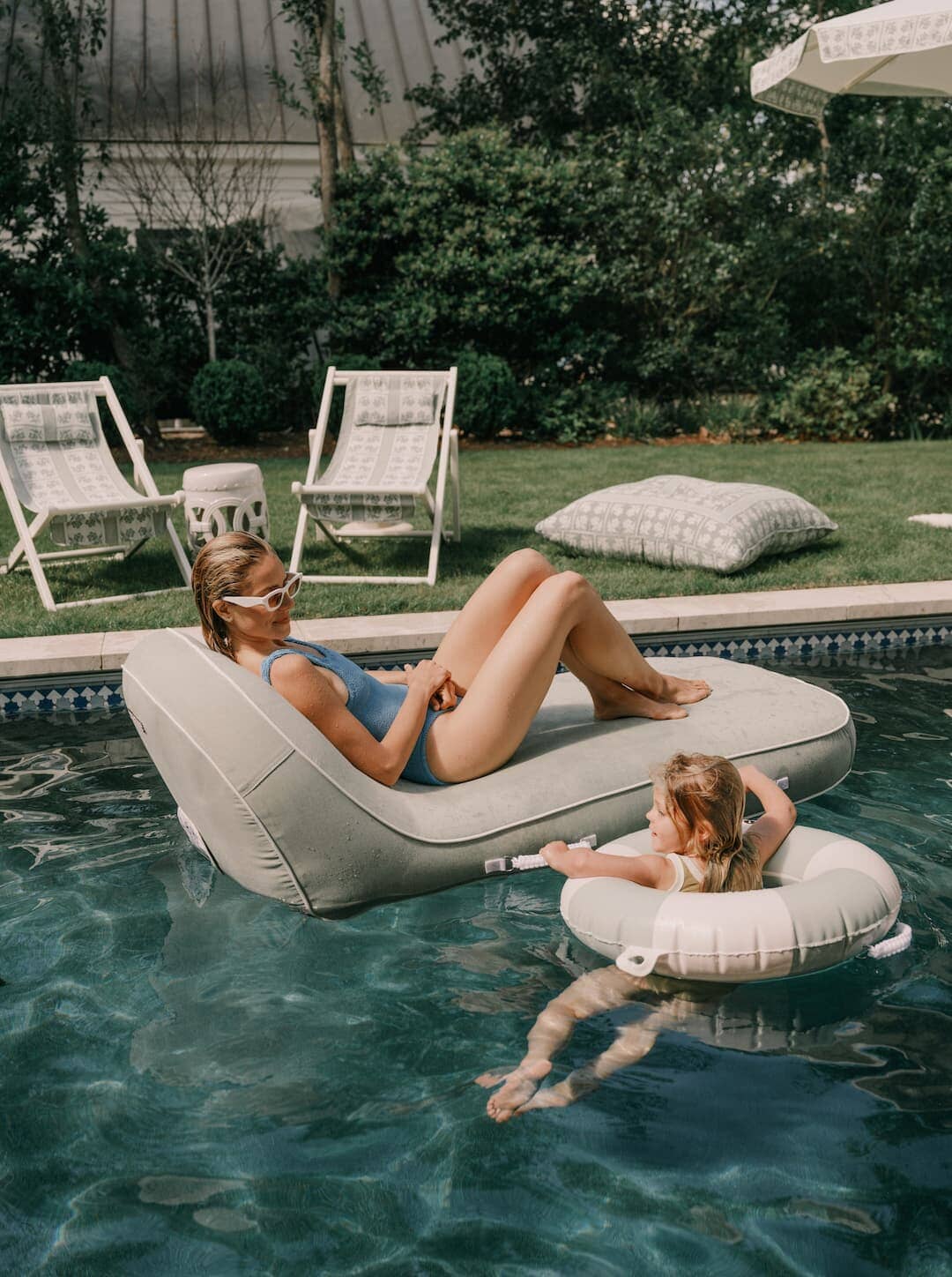 Woman laying on pool lounger in the pool