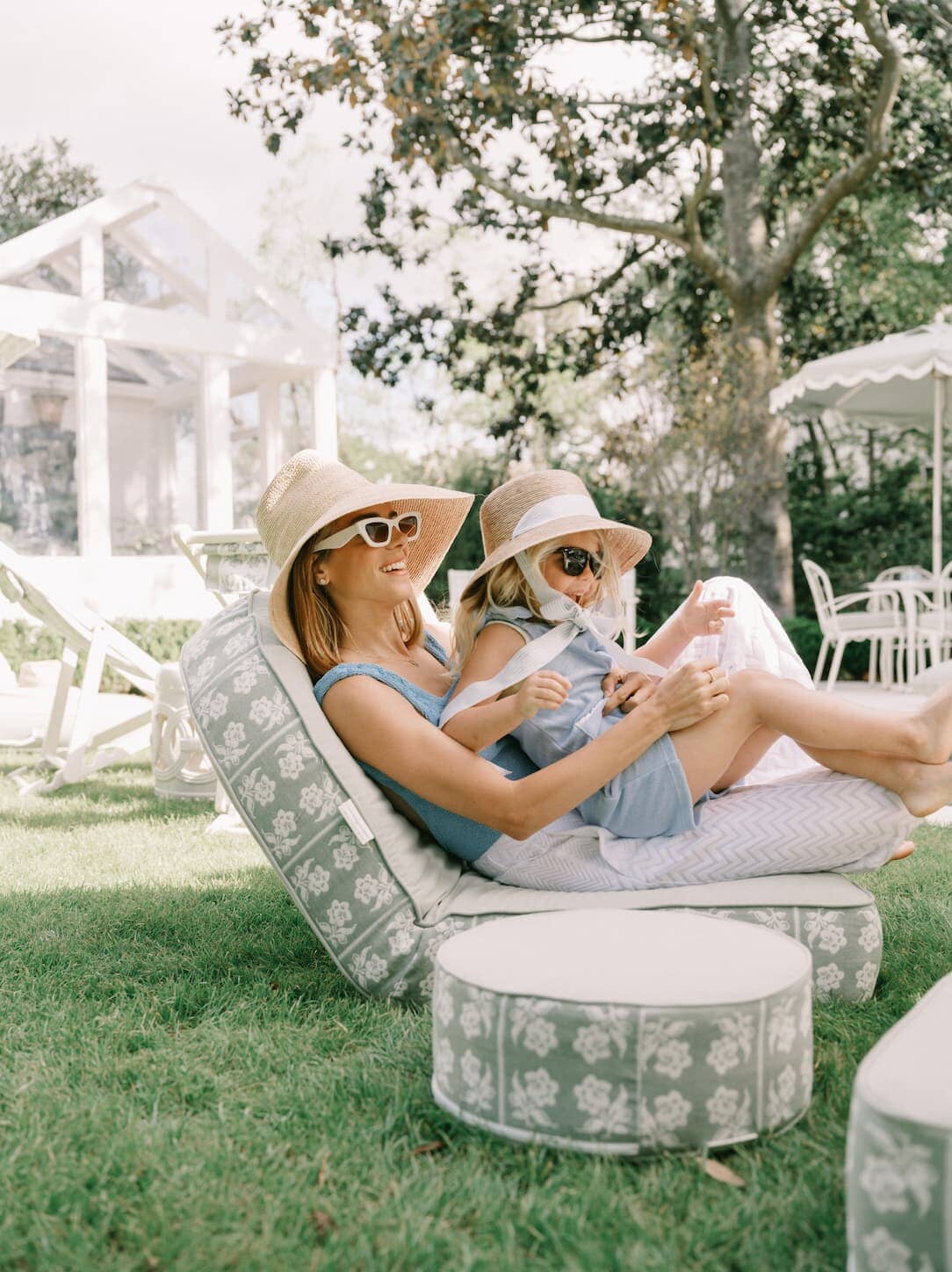 Mother and daughter relaxing on the reclining pillow lounger