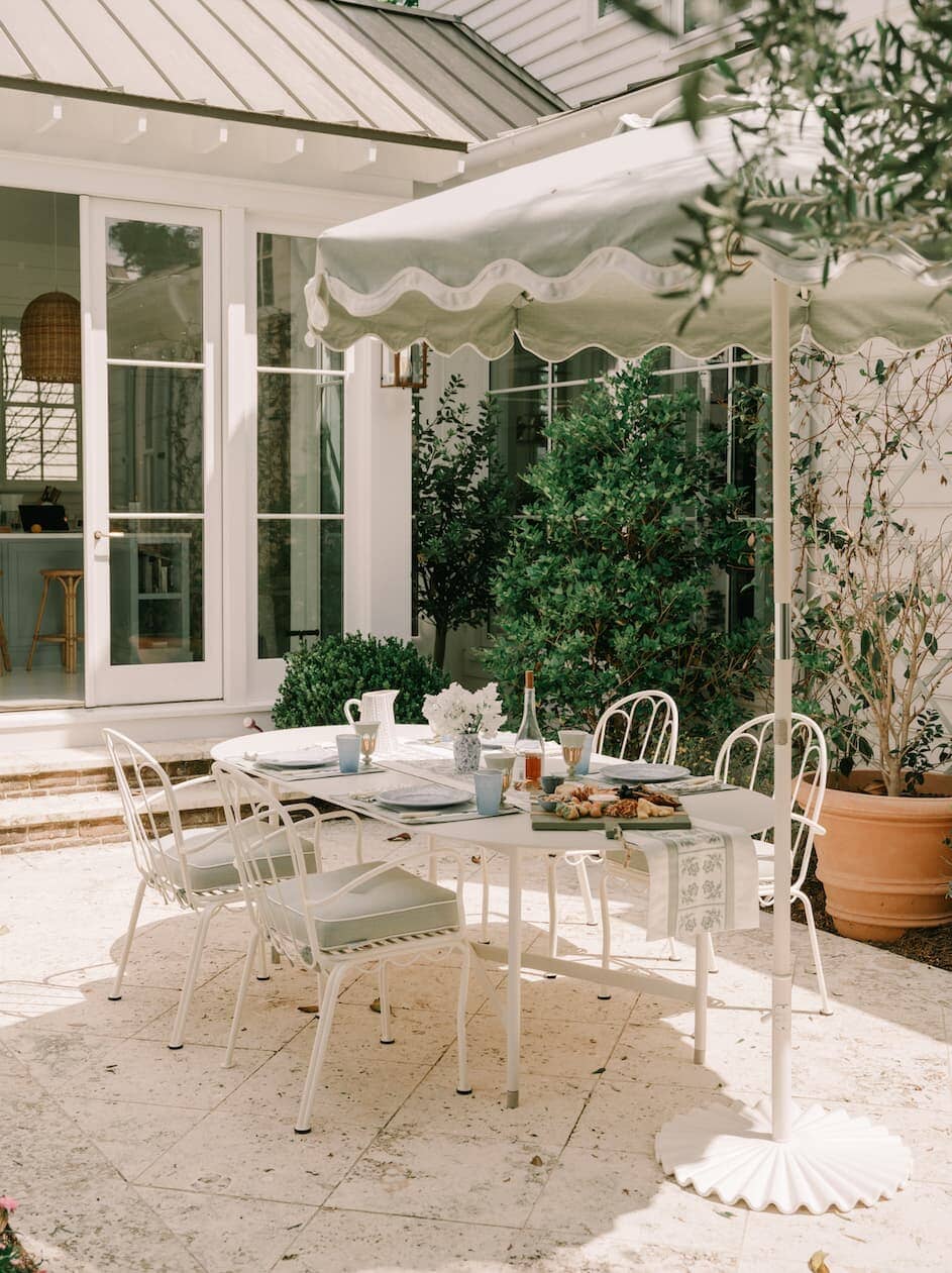 Outdoor patio dining area with table, chairs and umbrella