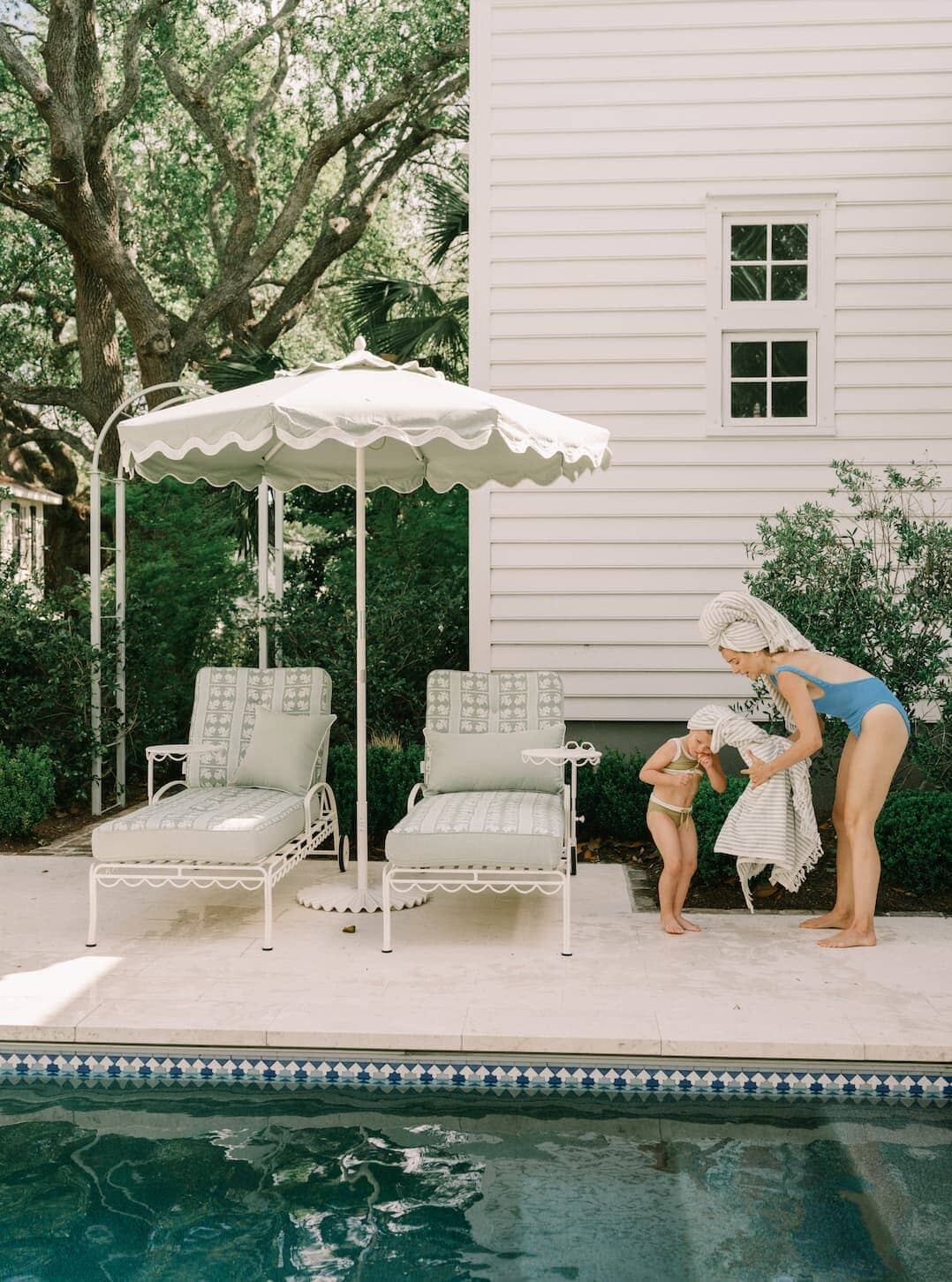 Pool area with mother and daughter drying off