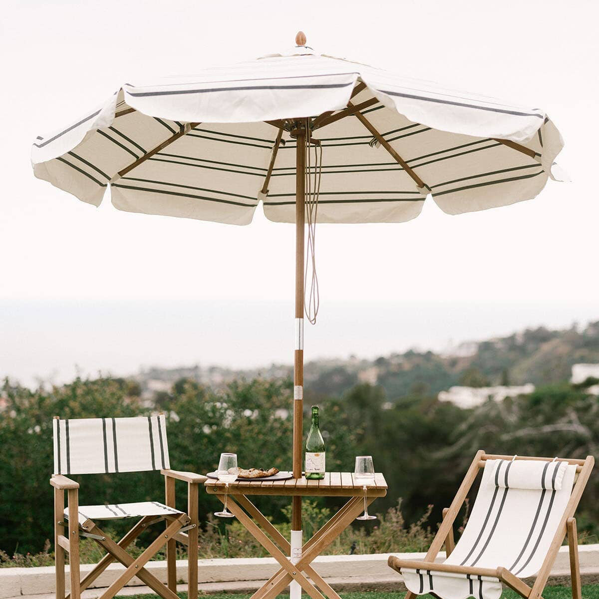Malibu black stripe umbrella and chairs on grass