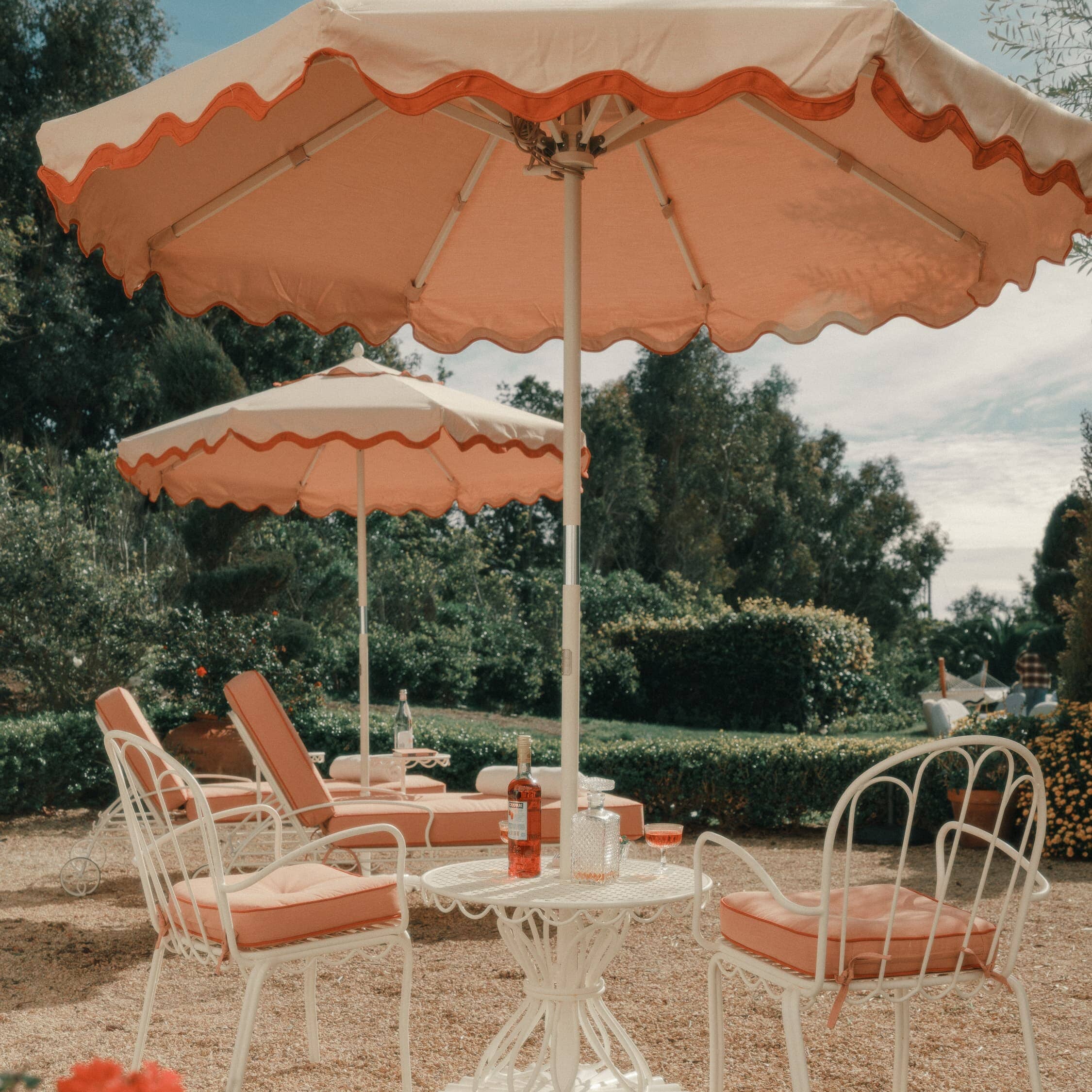 Riviera pink market umbrella and pink al fresco chairs on a patio