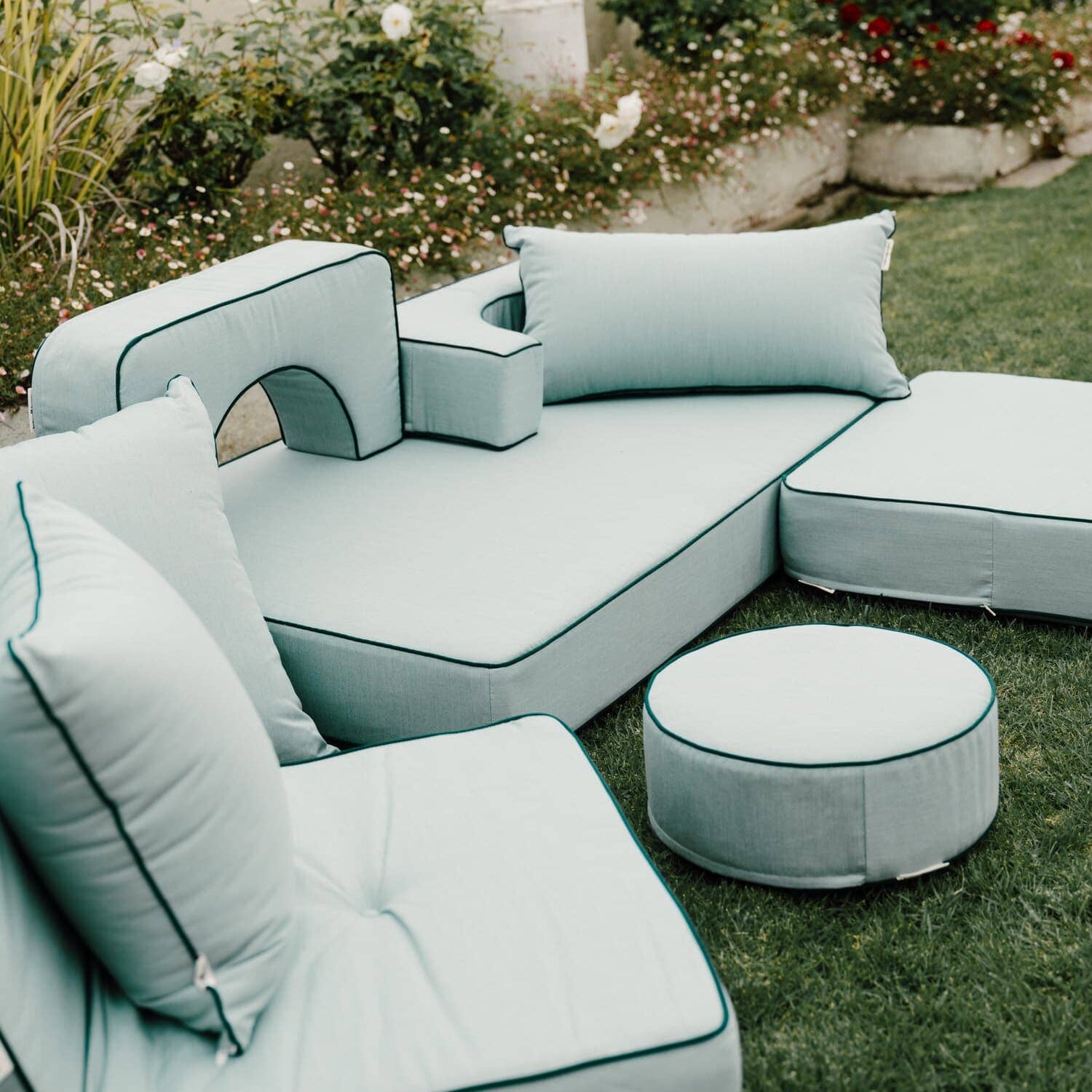 Riviera green modular pillow stack in a garden setting