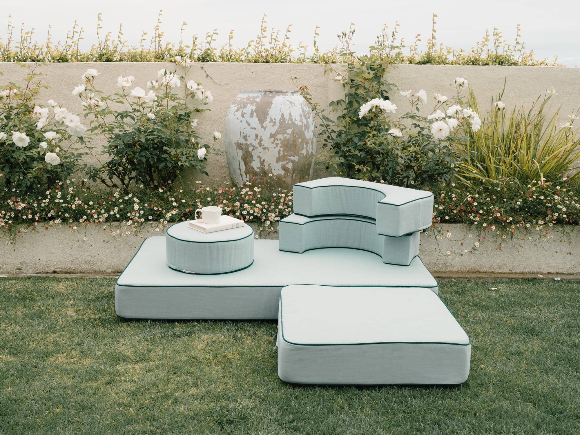 Riviera green modular pillow stack in a garden setting