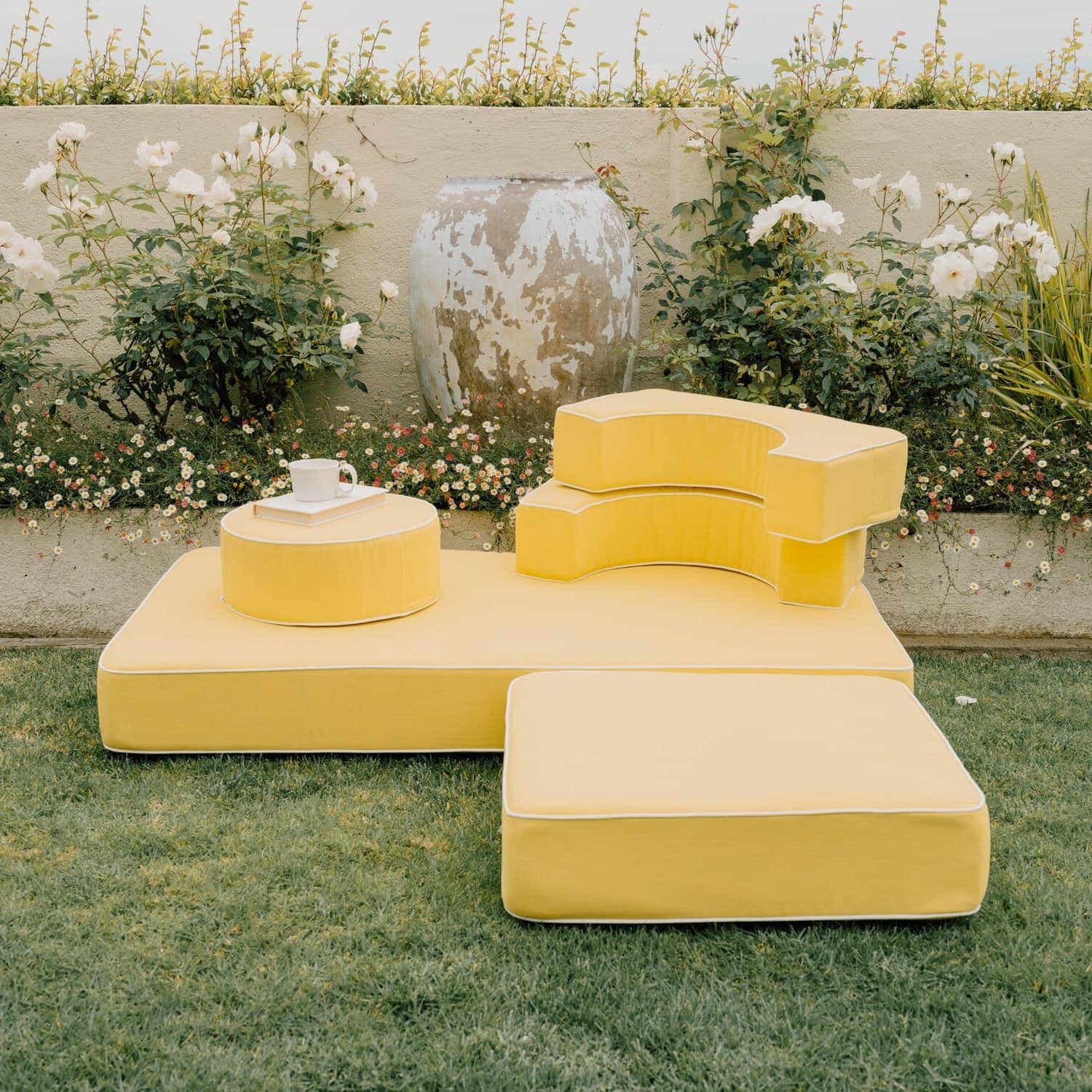 Riviera mimosa modular pillow stack in a garden setting