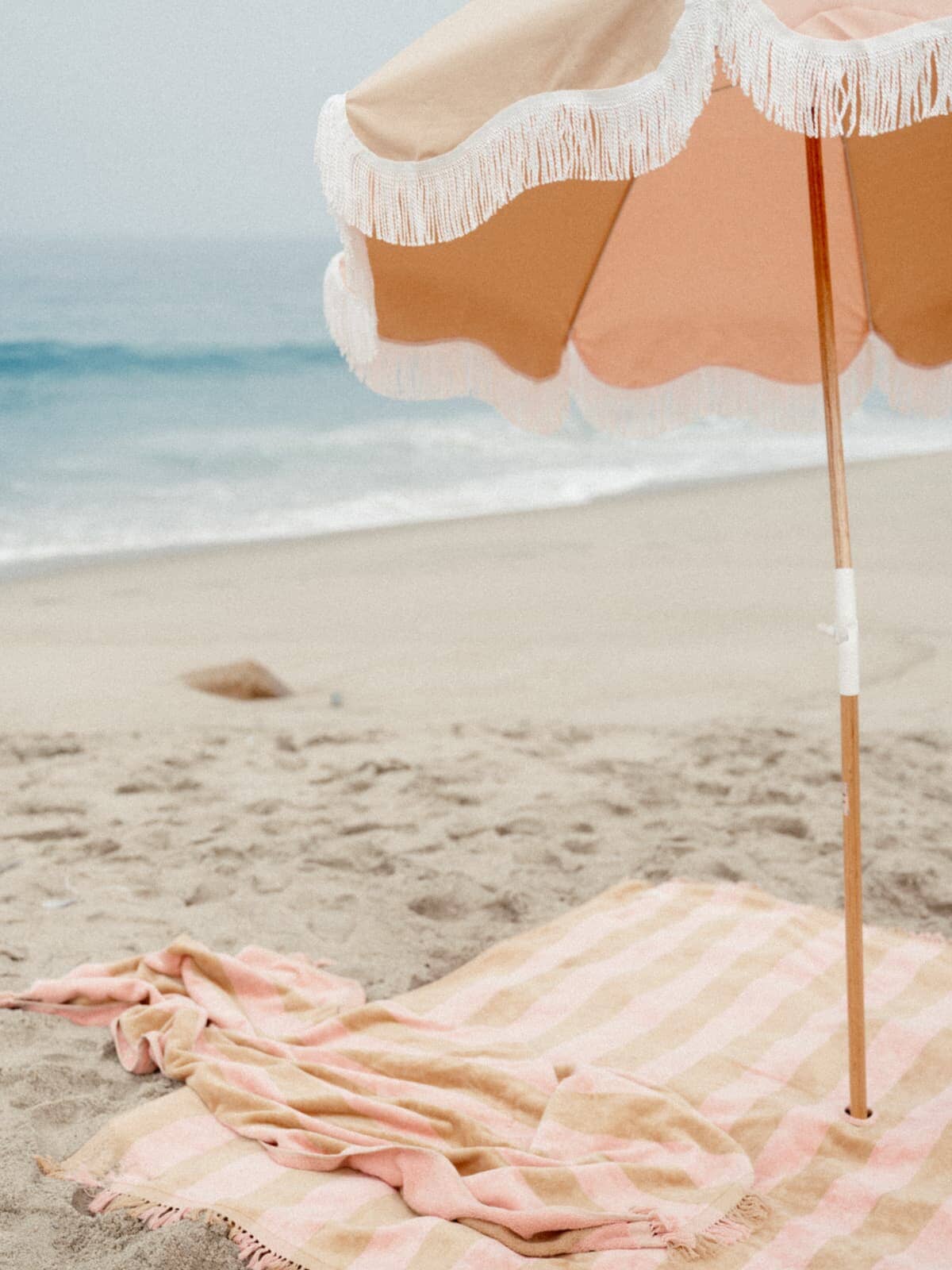 Sand & pink holiday umbrella on the beach