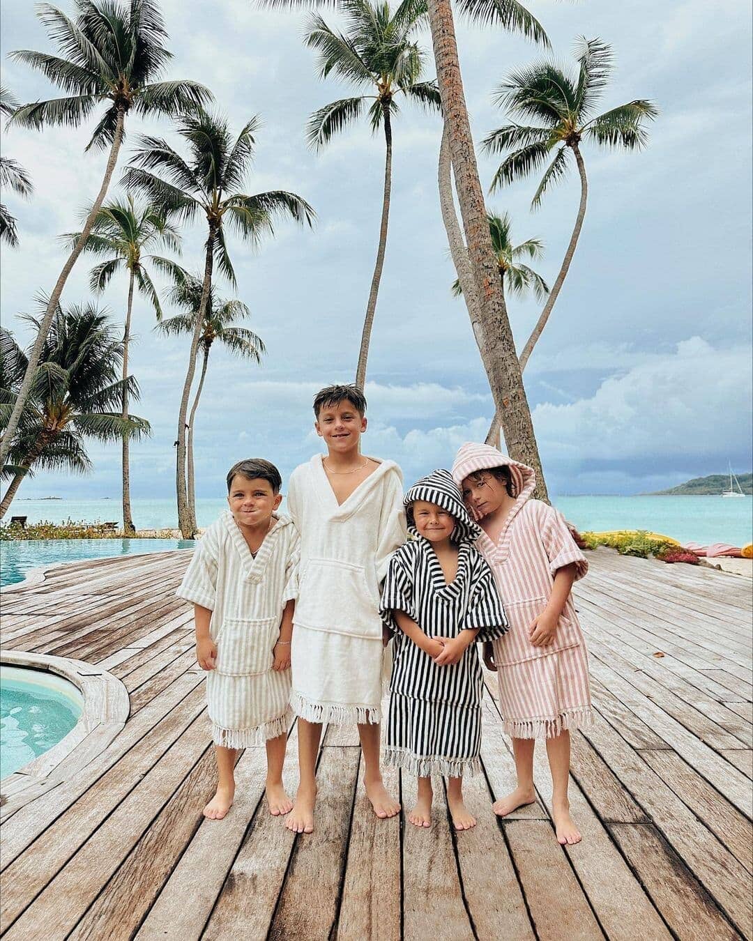 Four kids wearing all colors of the kids poncho