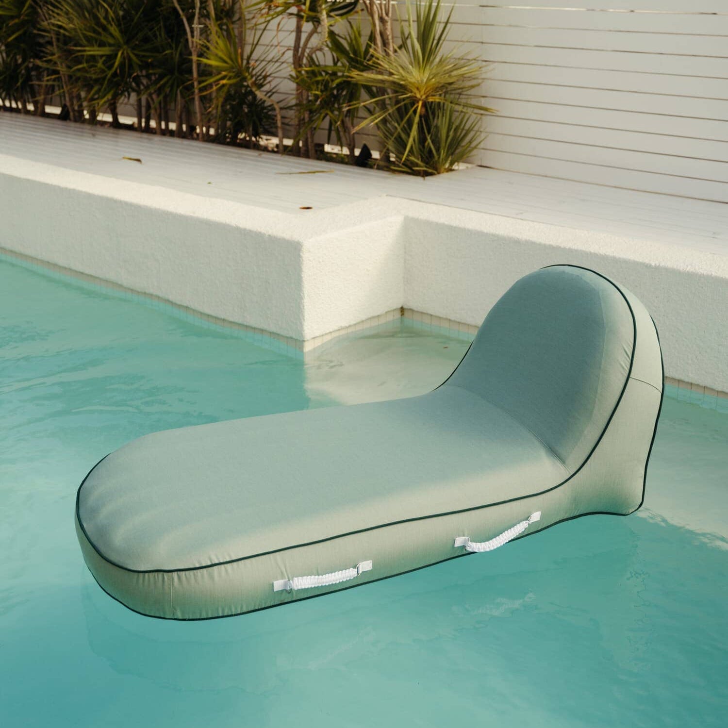 Riviera green pool lounger in a pool