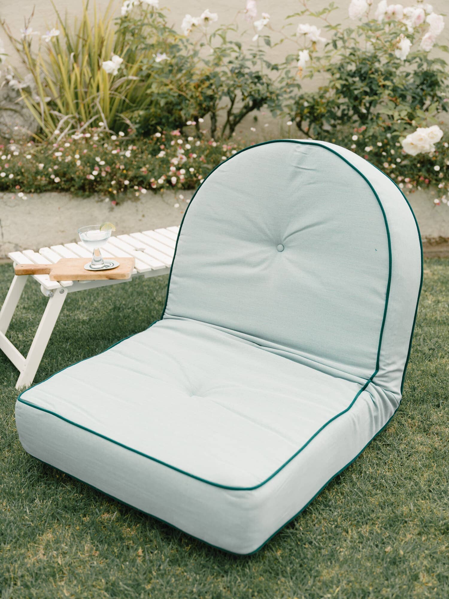 Reclining pillow lounger in a garden setting