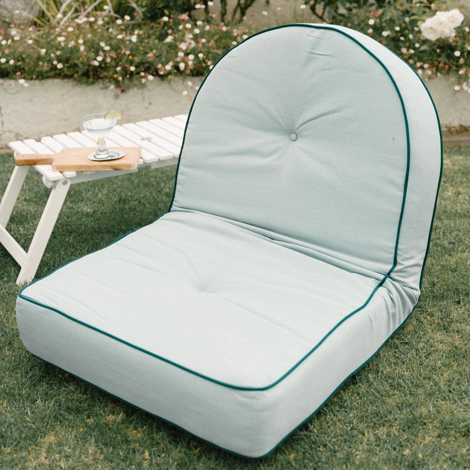Reclining pillow lounger in a garden setting