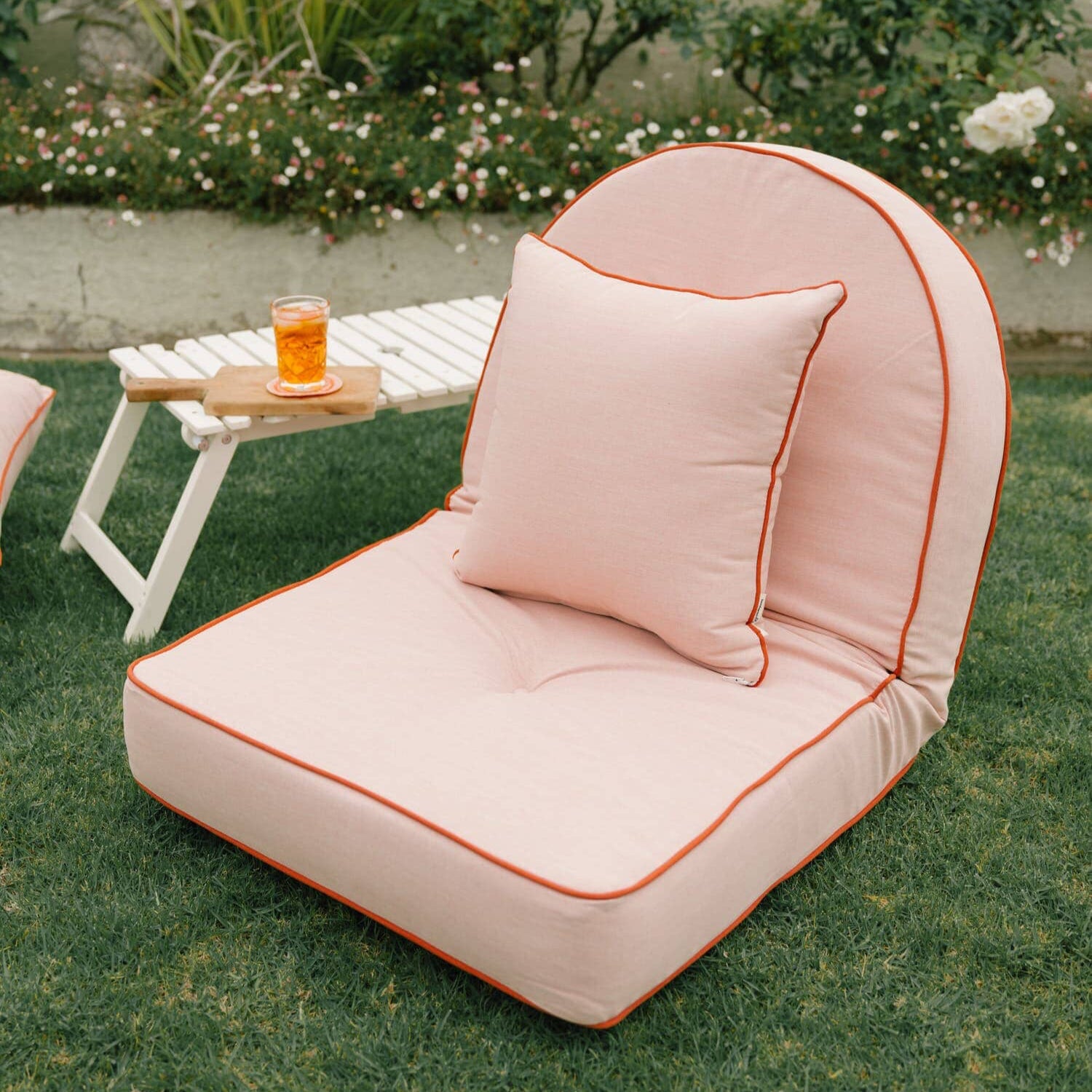 Riviera pink pillow lounger in a garden setting