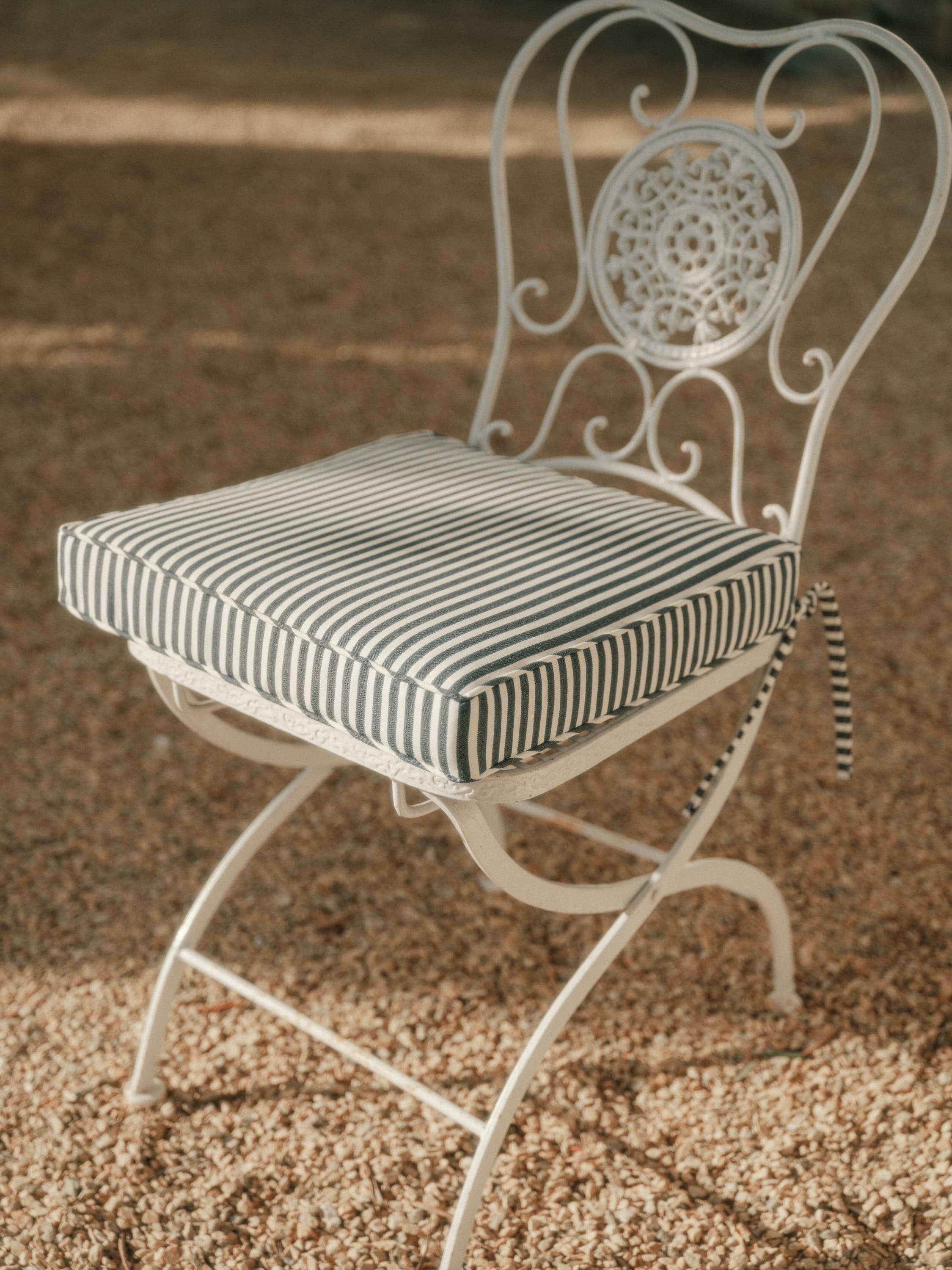 navy seat pillow on metal frame chair