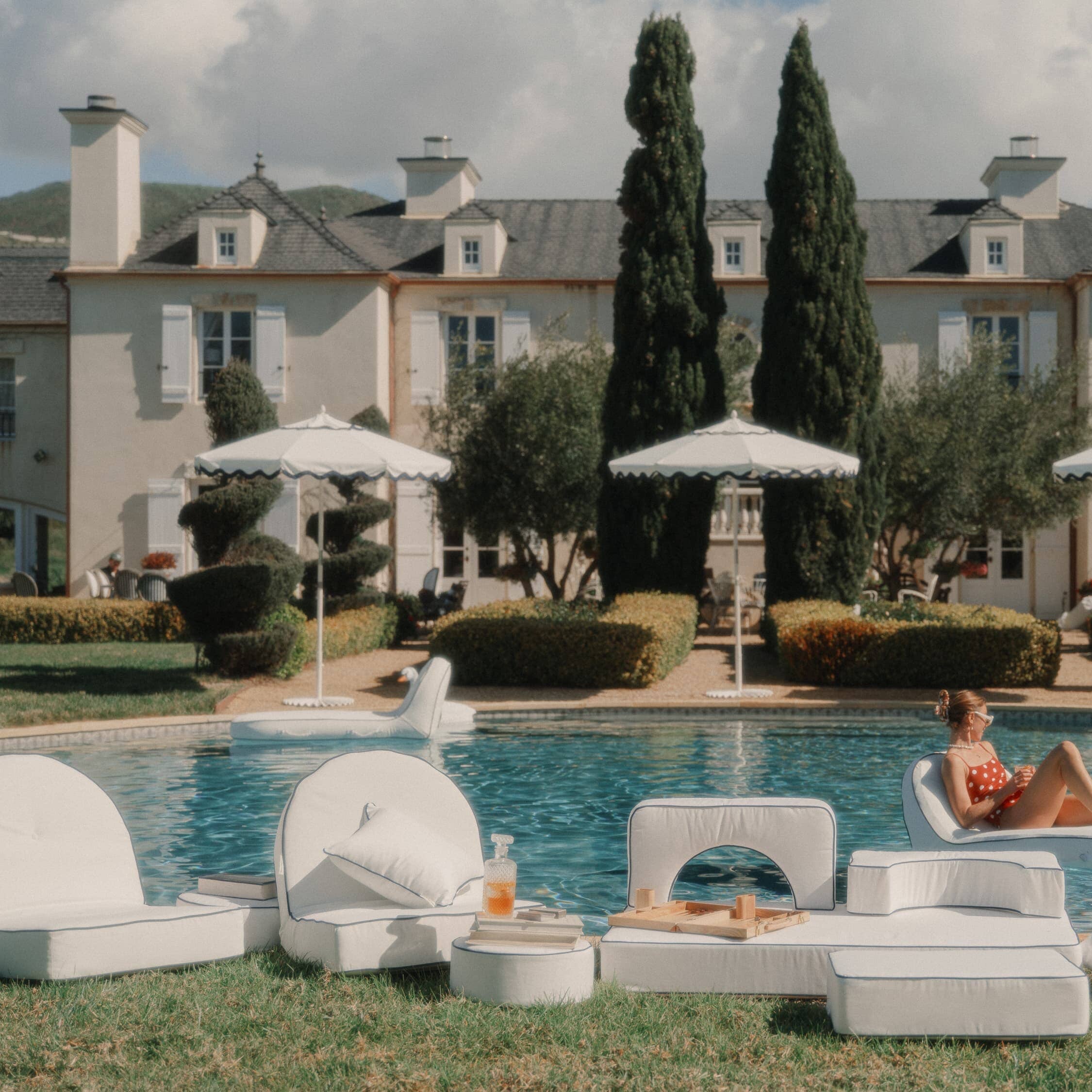 White outdoor cushions next to a pool