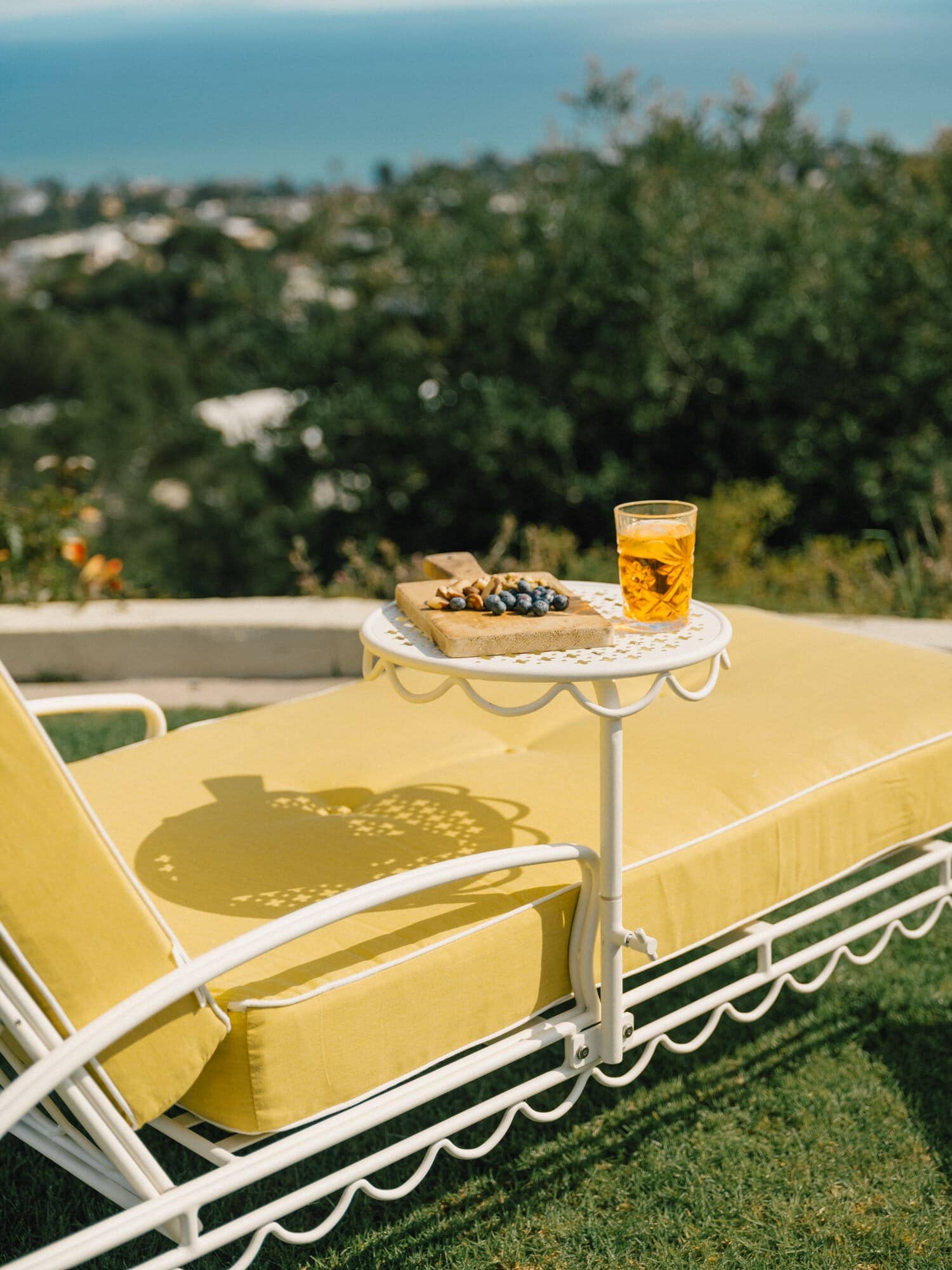 Riviera mimosa sun loungers and umbrella on a grass area