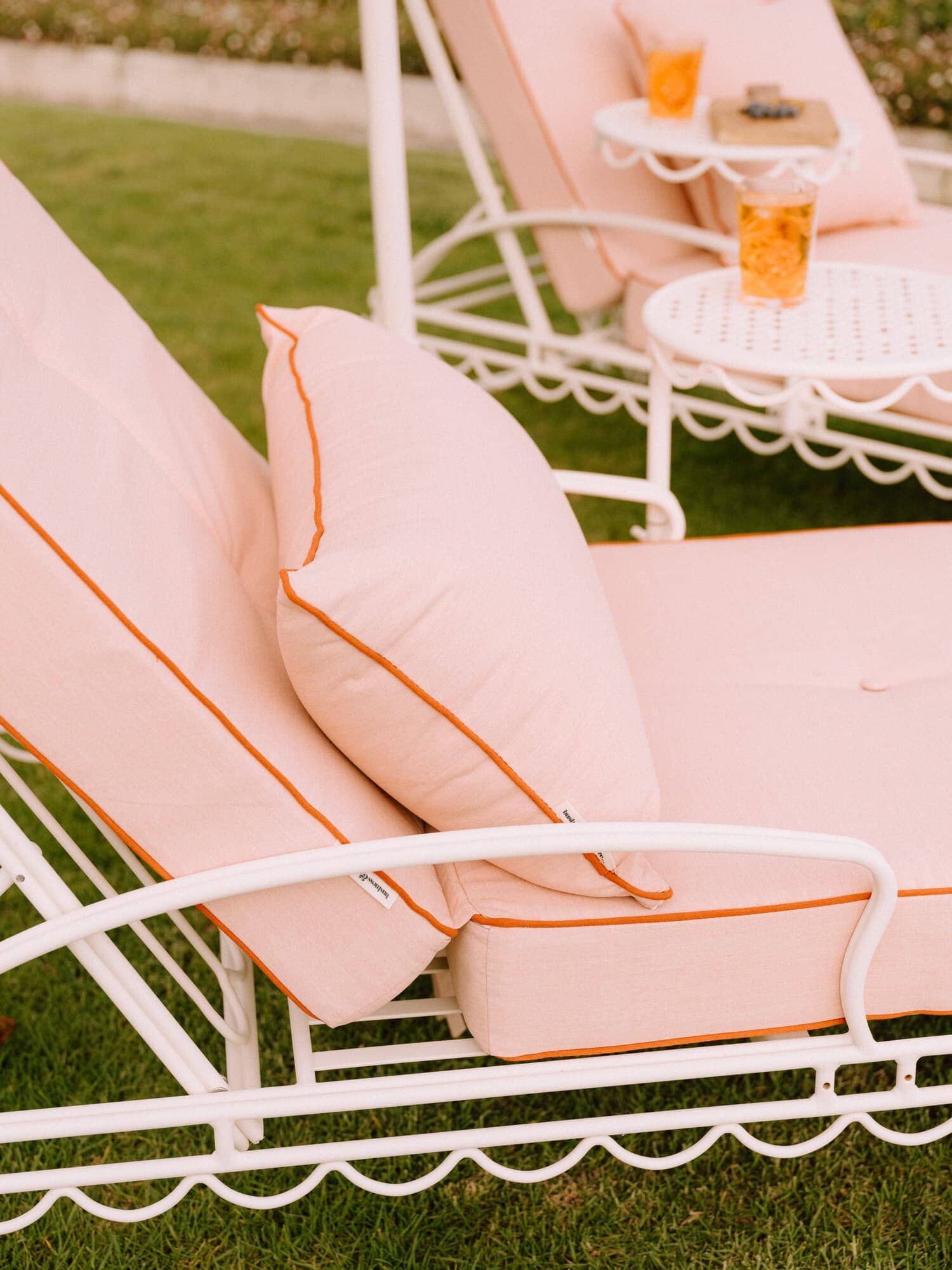 Riviera pink sun loungers with umbrella on the grass