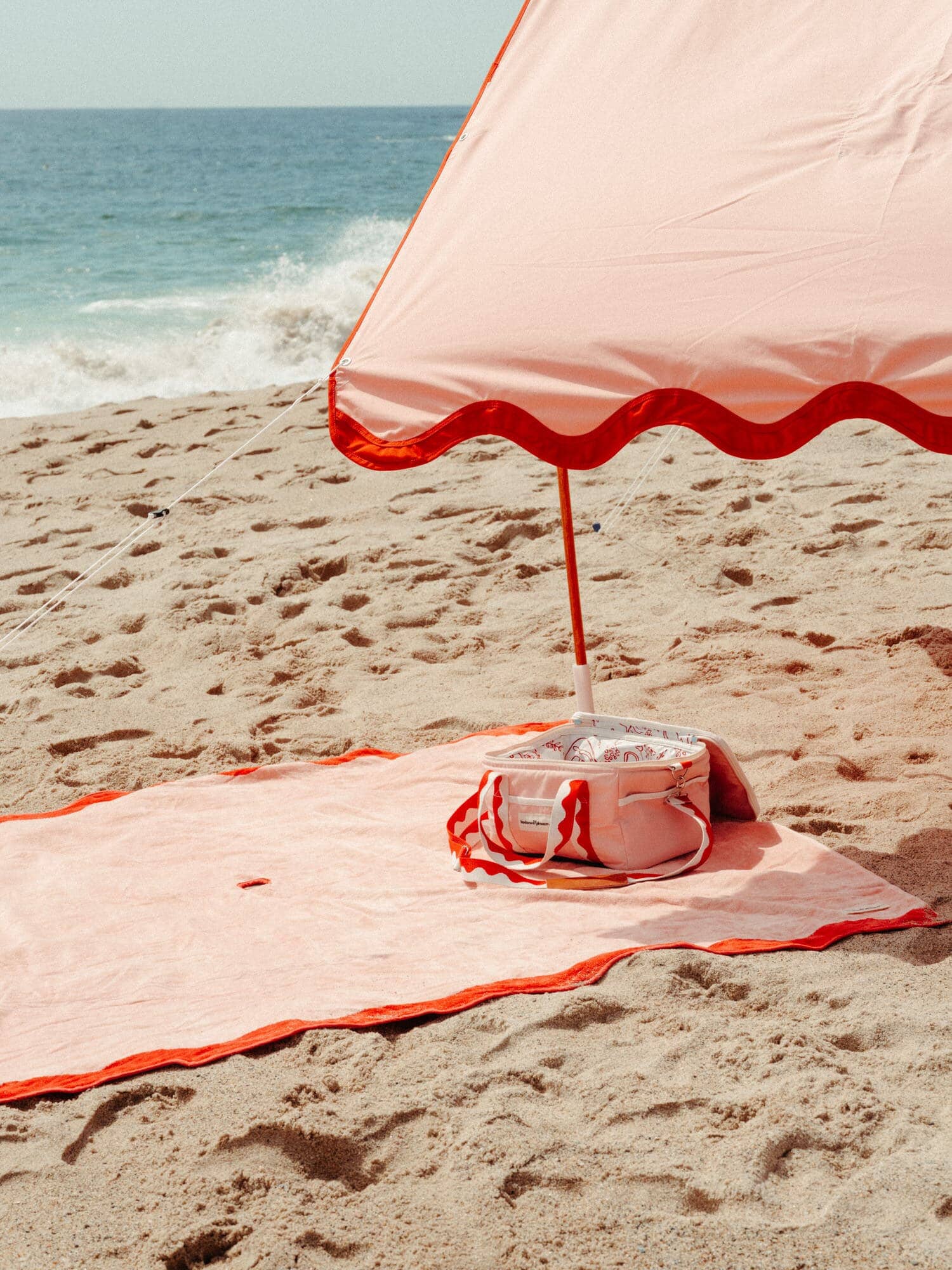 Riviera pink beach tent with matching accessories on the beach
