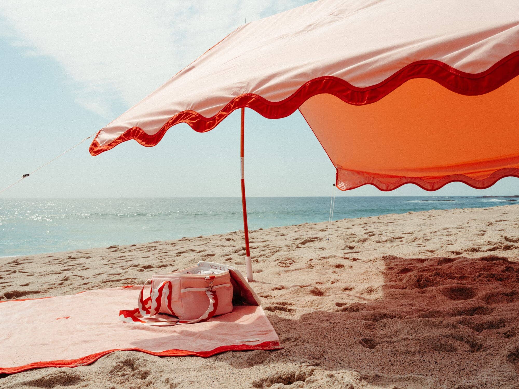 Riviera pink beach tent with matching accessories on the beach