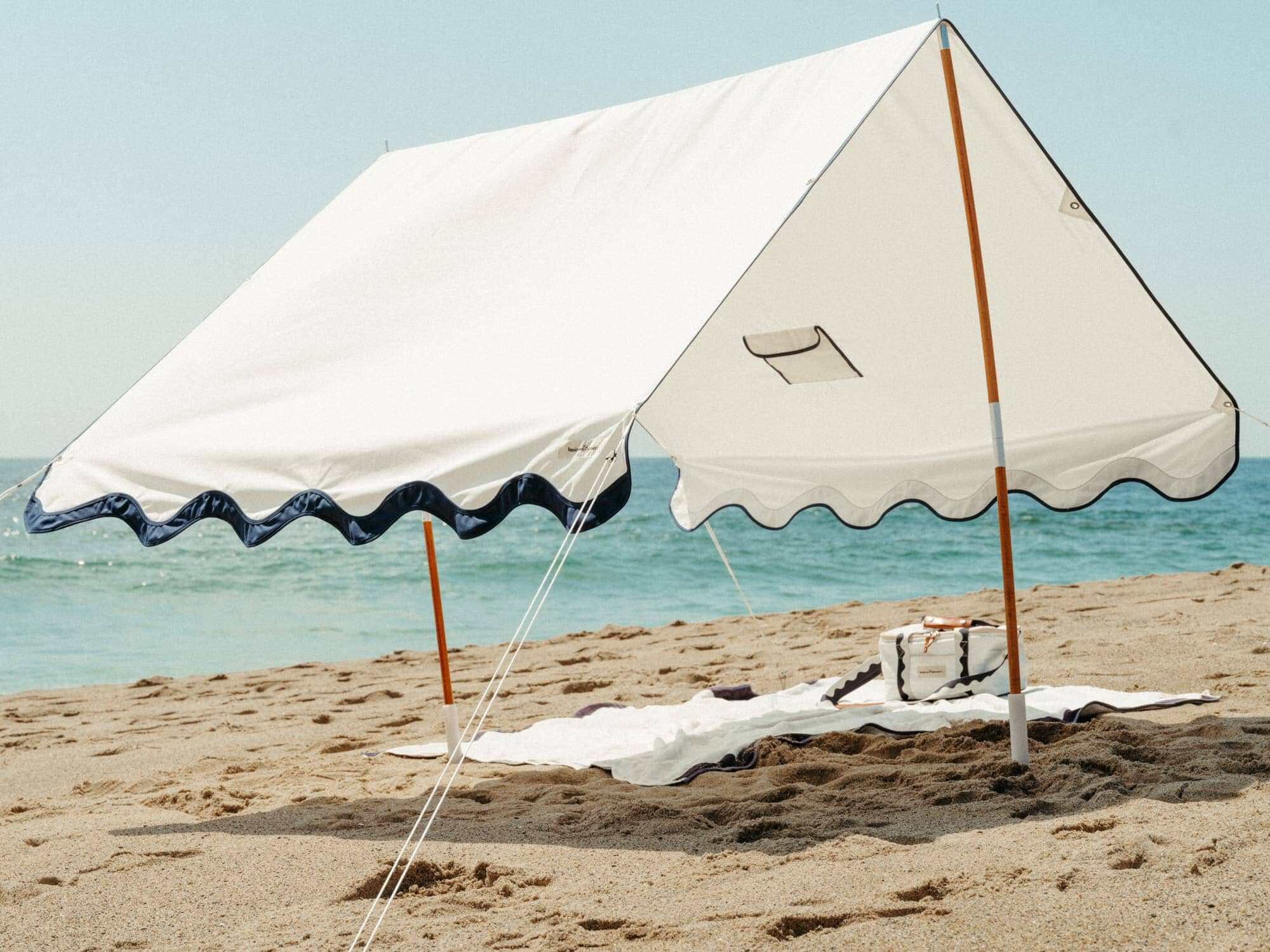 Riviera white tent with matching accessories on the beach