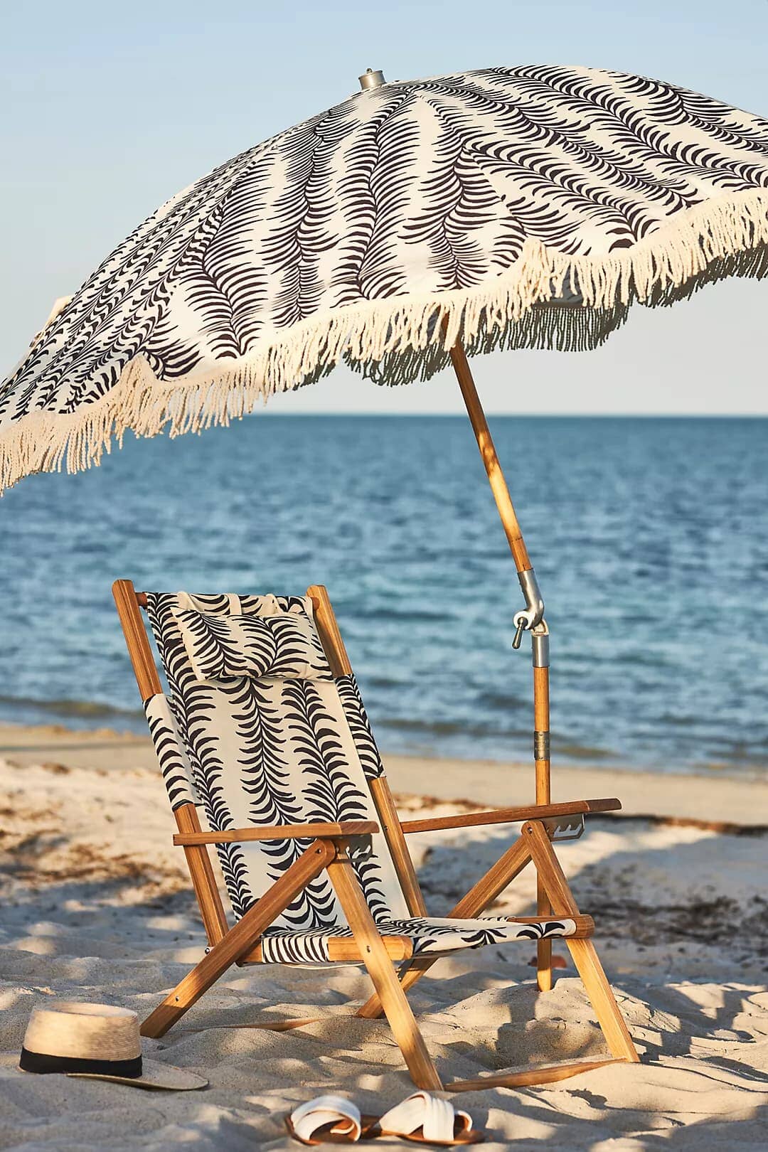 Black palm tommy and umbrella on the beach