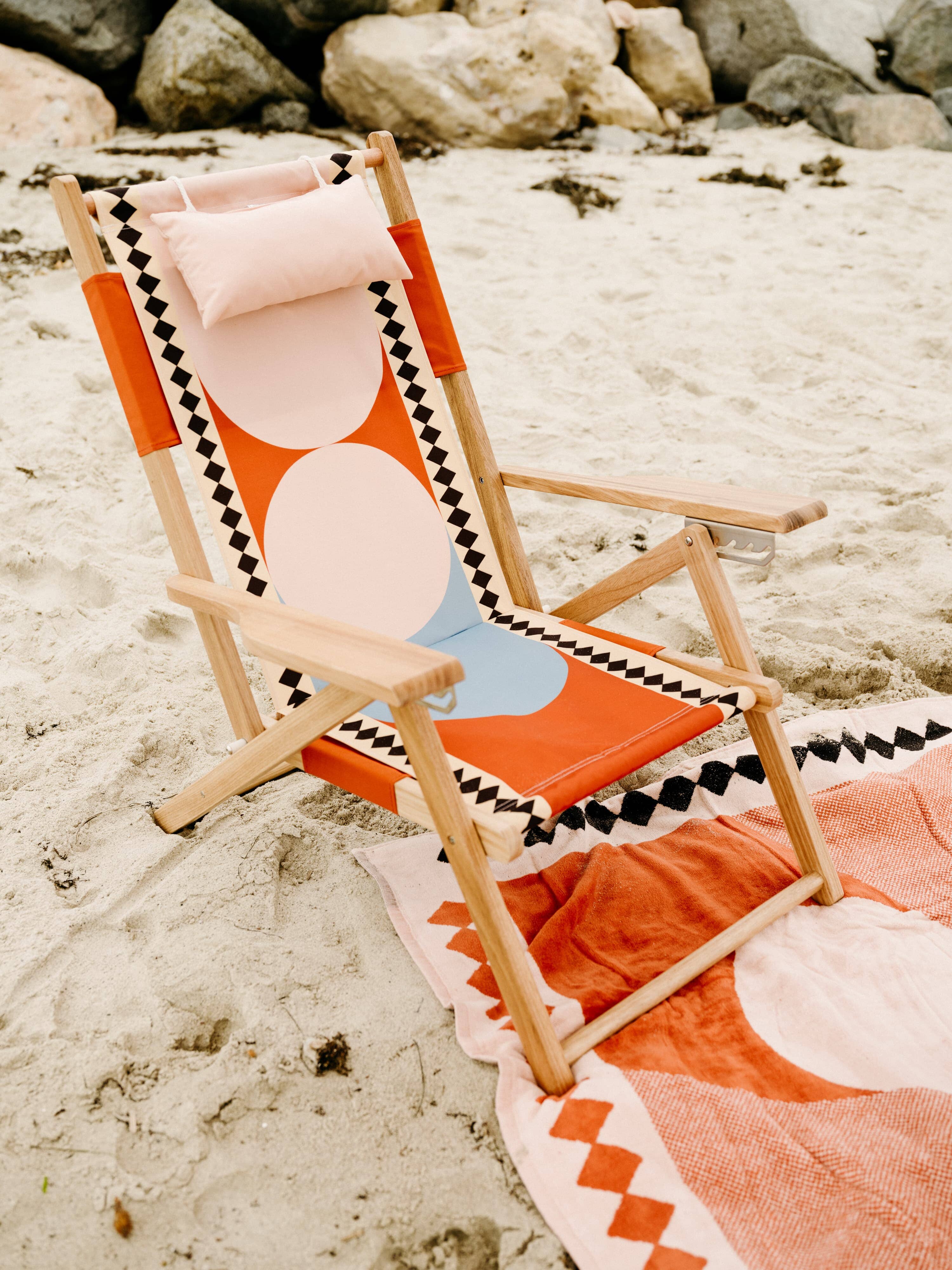 Beach set up with diamond pink umbrella, blanket & chair