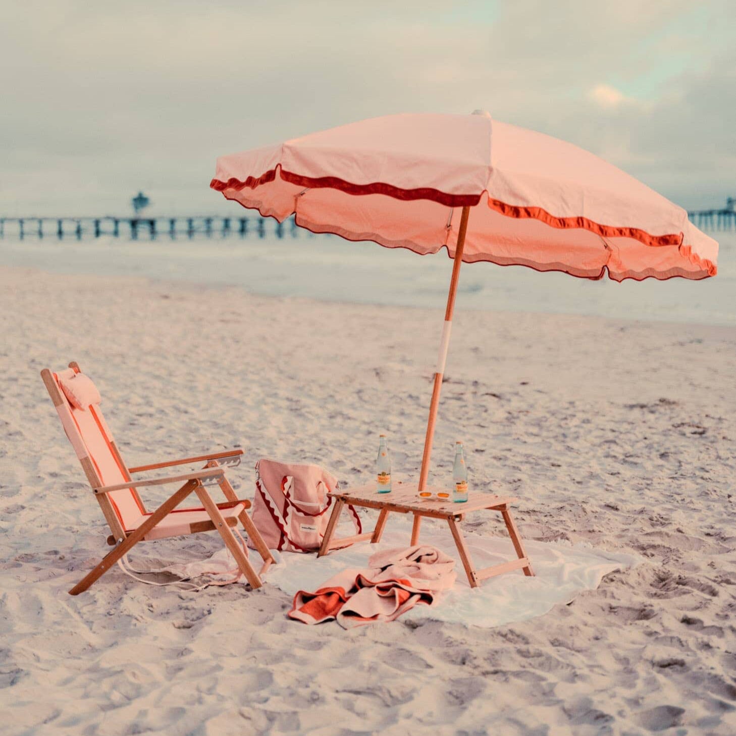 Rivie pink beach set up with chair, umbrella and cooler