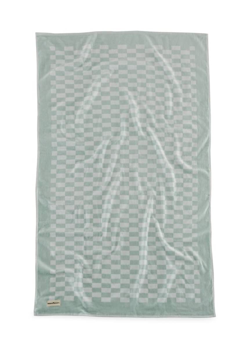 Studio image of light green checker towel