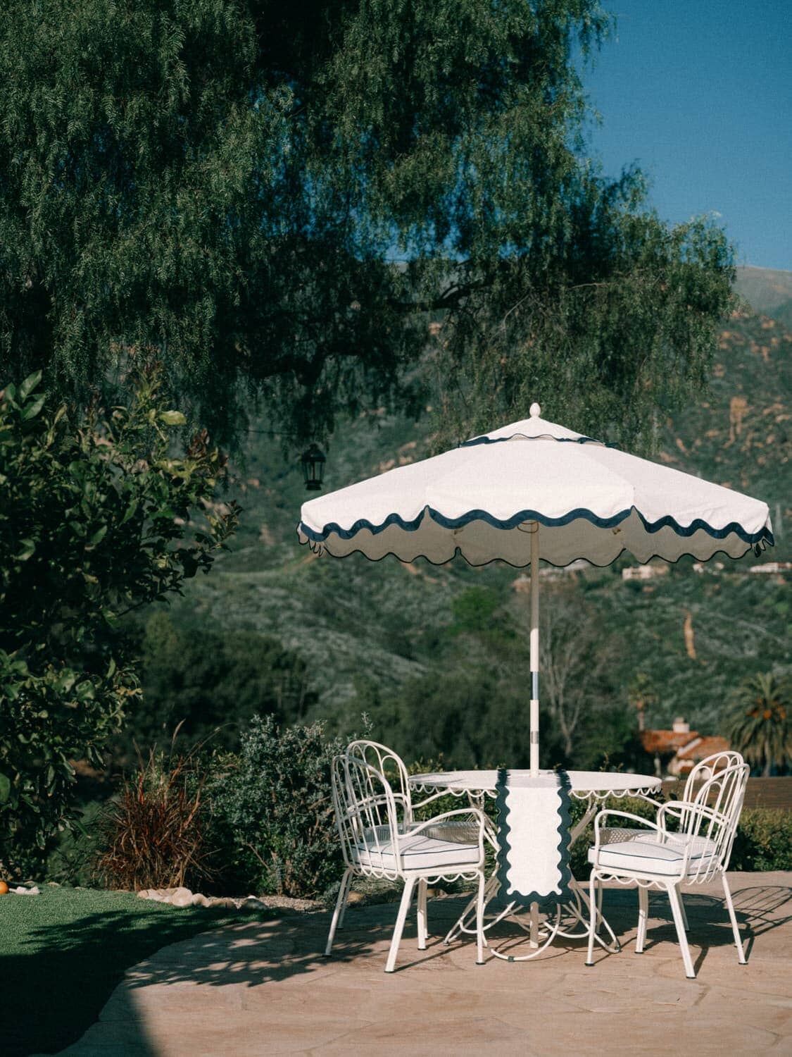 al fresco dining chair on a patio with a white table setting