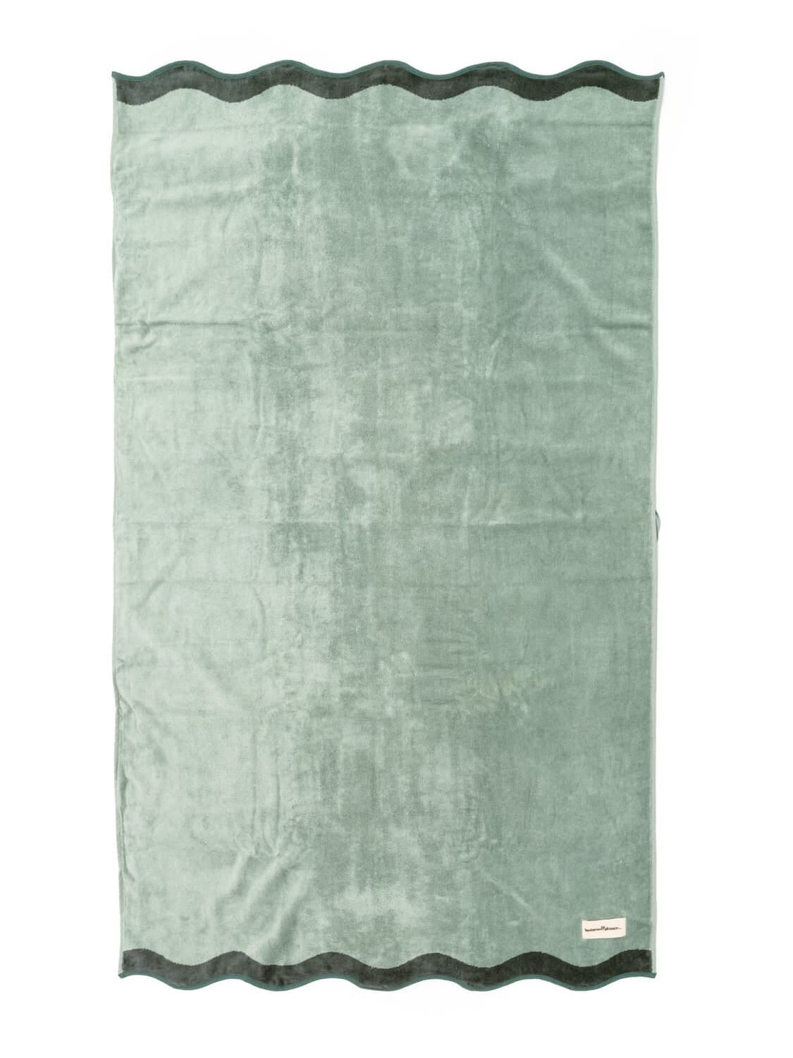 Studio image of Riviera Green Beach towel laying flat.