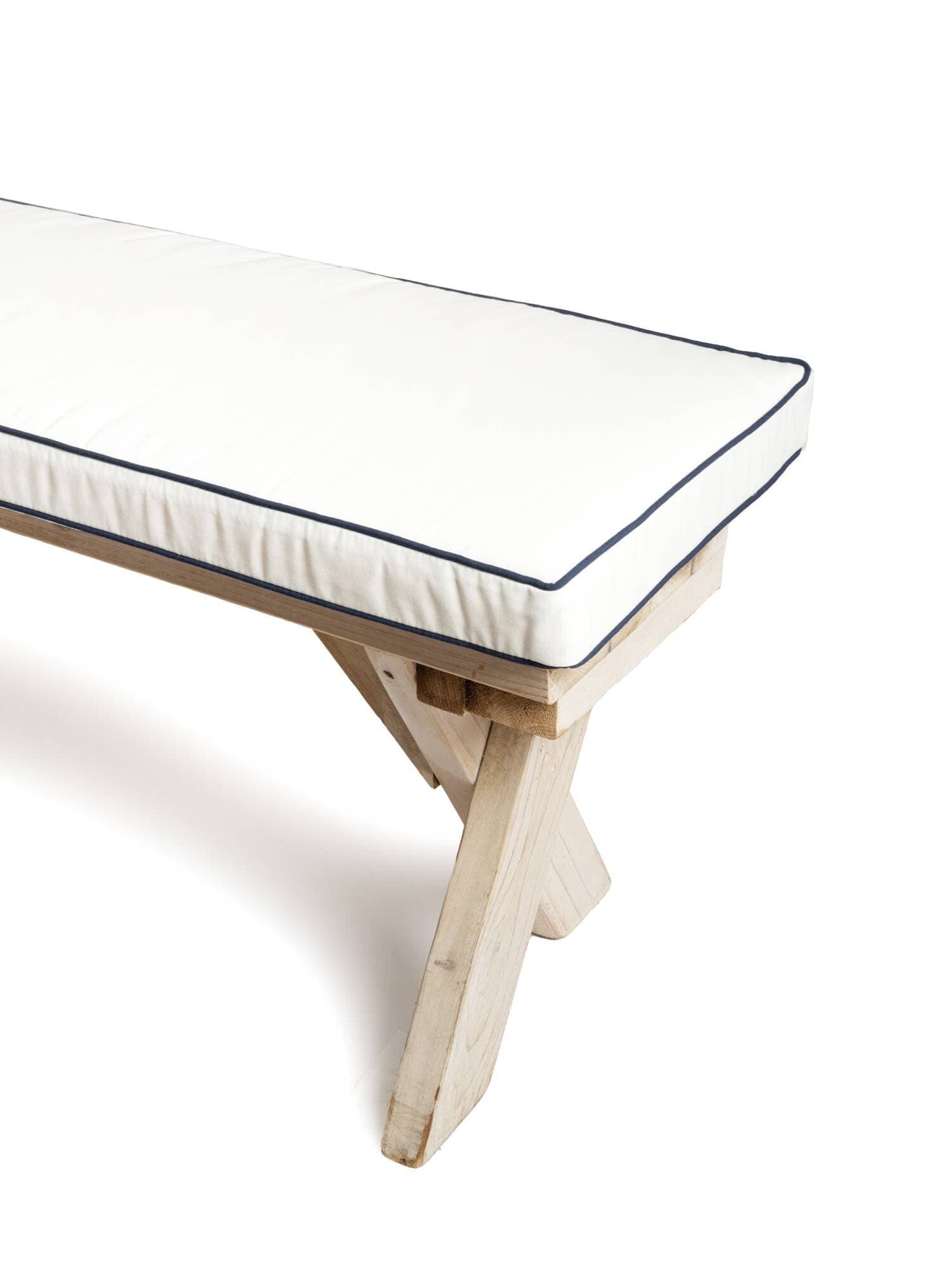 studio image of antique white bench pillow on a wooden bench
