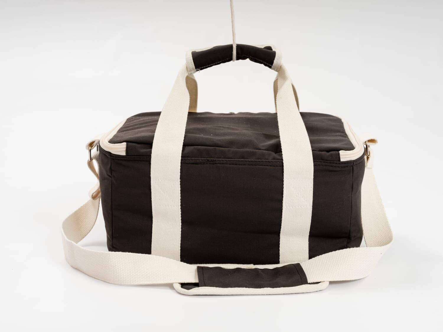 studio image of back of vintage black holiday cooler bag