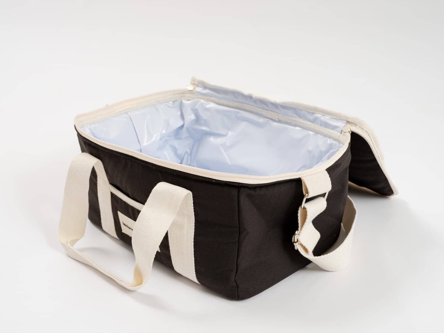 studio image of vintage black holiday cooler bag interior