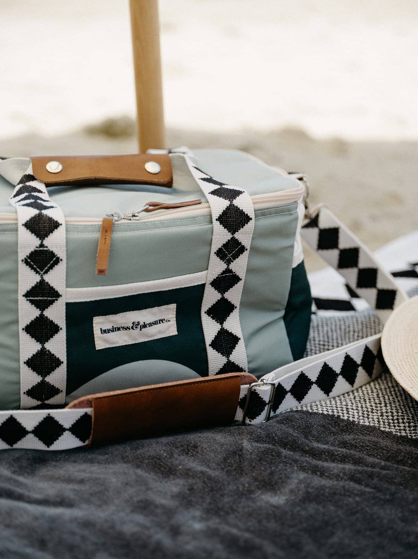 green diamond cooler on towel at beach